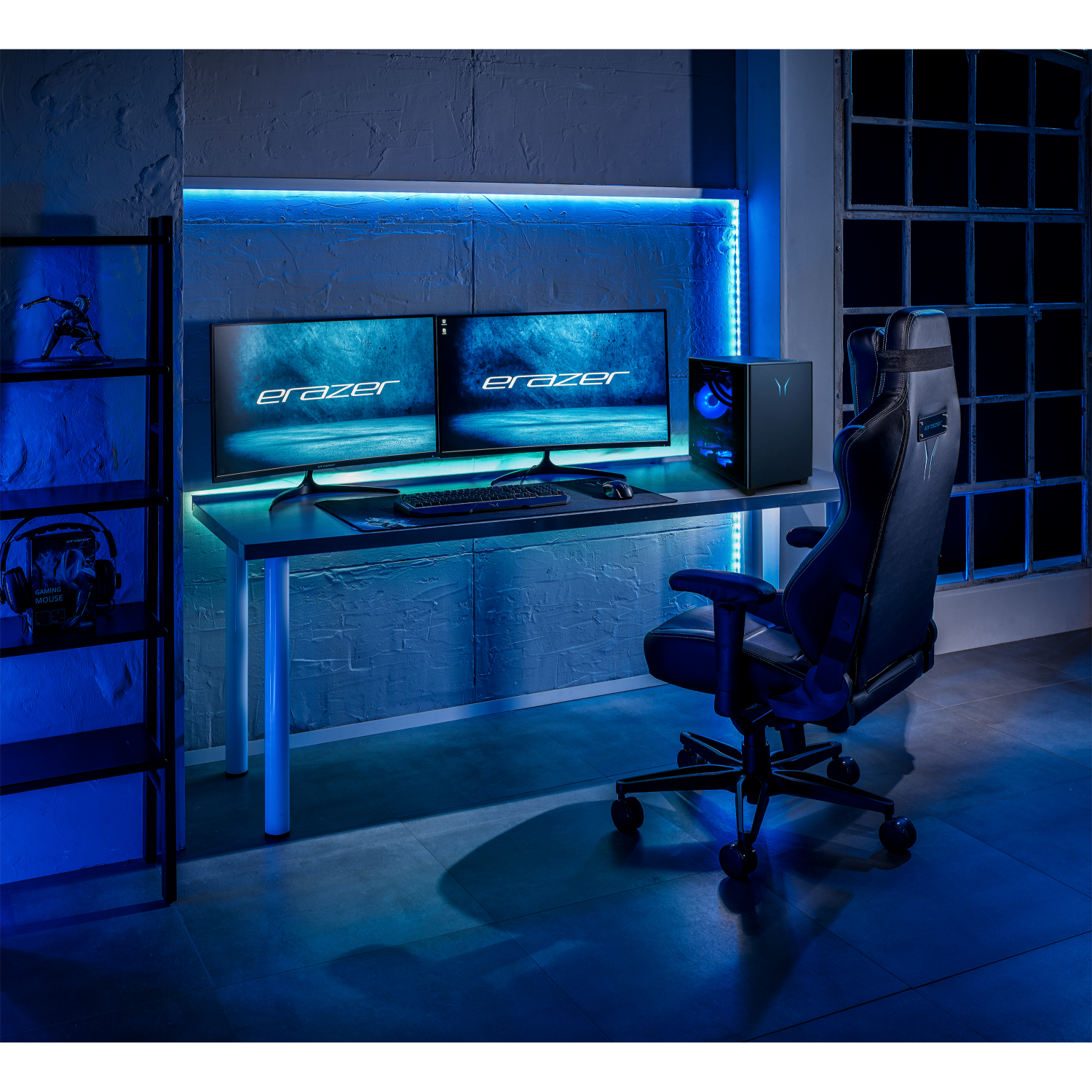 Een gaming-setup met dubbele monitoren, pc, stoel en plank, verlicht door blauwe LED's.