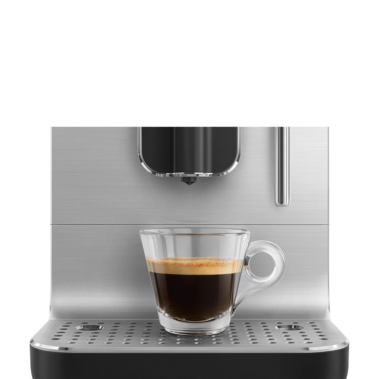 Eine Kaffeemaschine mit einem klaren Glasbecher gefüllt mit Kaffee auf weißem Hintergrund.