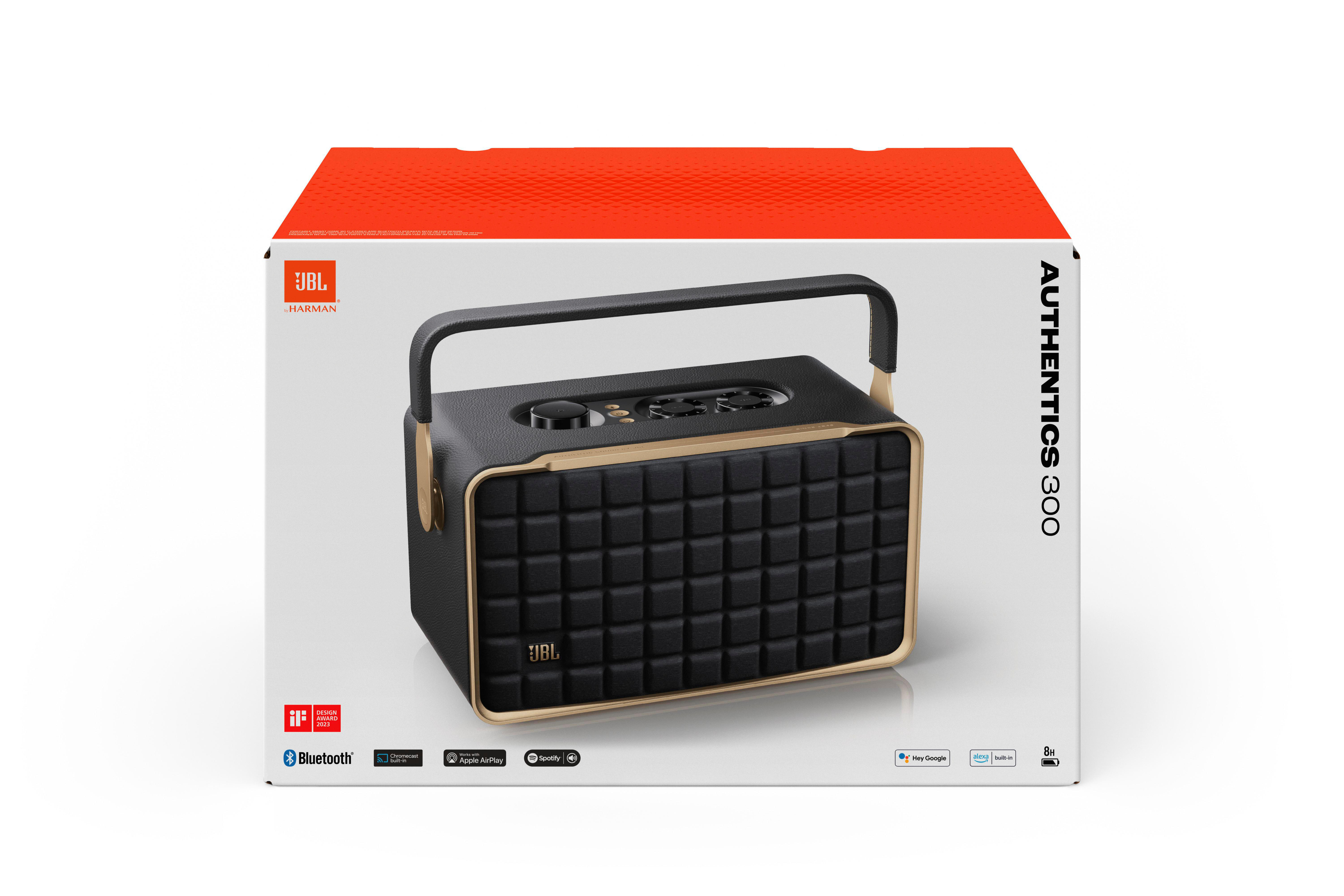 JBL Authentics 300 Lautsprecher in seiner Box. Er ist schwarz mit goldenen Akzenten, einem Griff und Branding.
