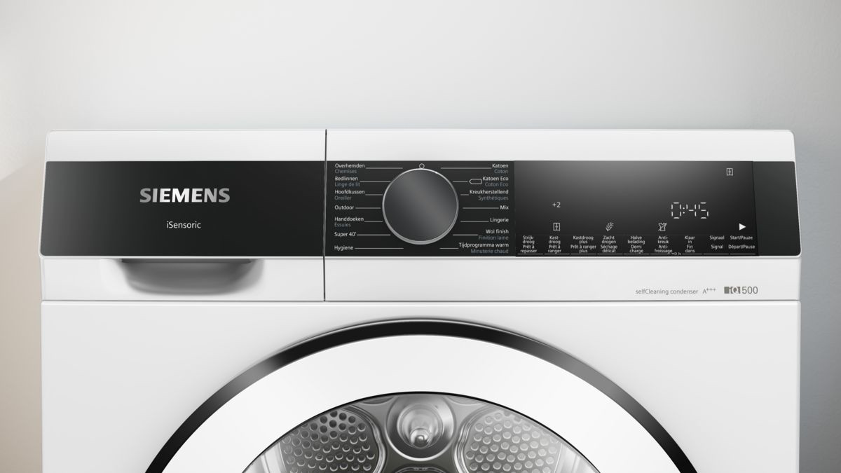 A close-up of a white washing machine control panel. Features a black screen with various buttons.