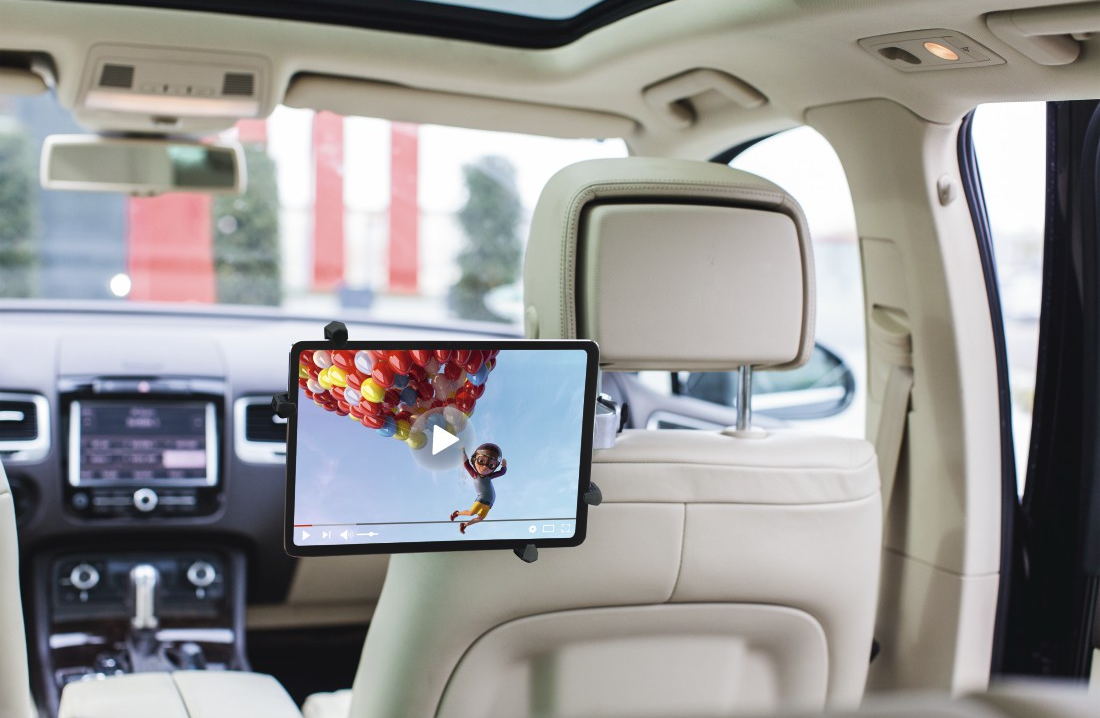 Tablette affichant une vidéo dans une voiture, montée à l'arrière d'un siège.