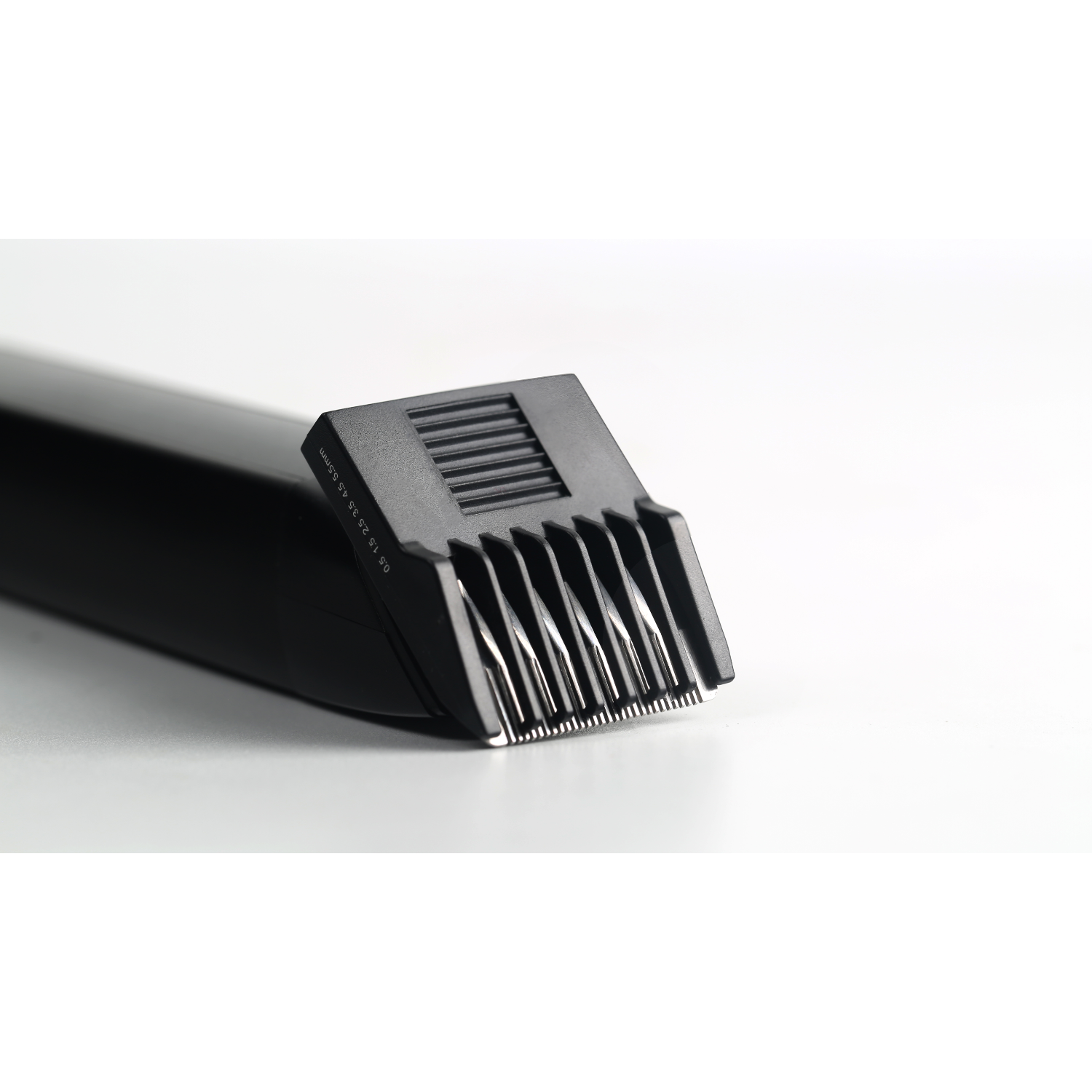 A trimmer head on white surface, with blade details.
