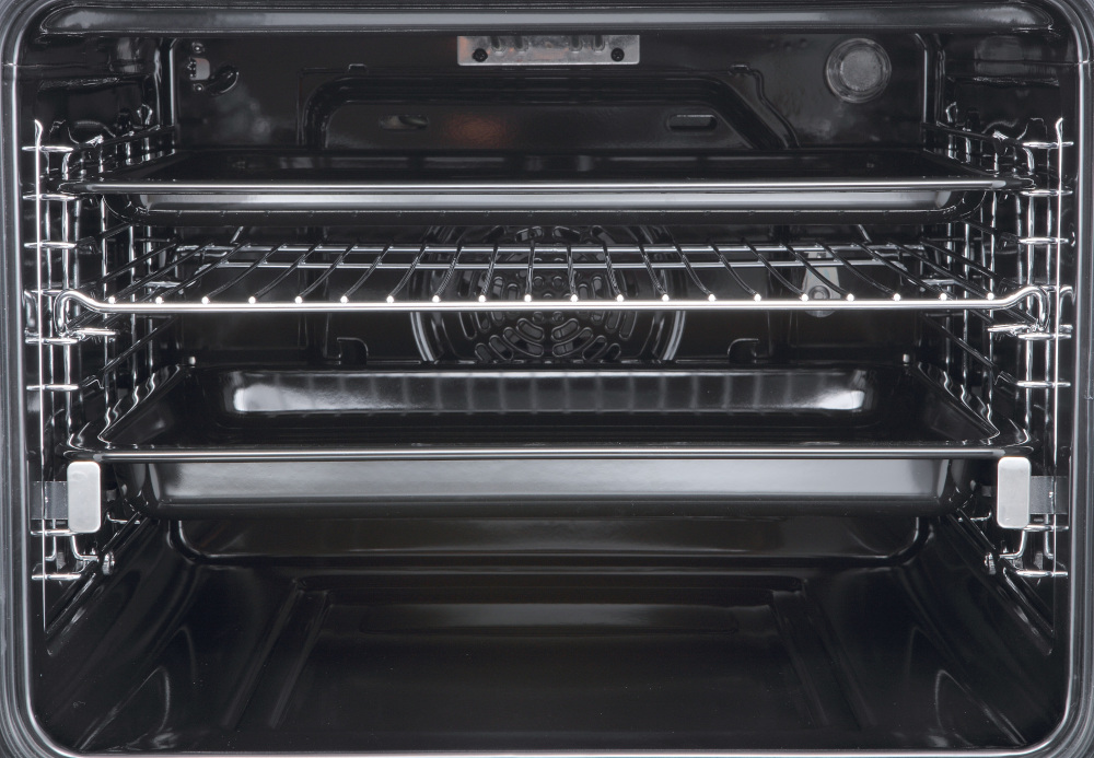 Oven interior. Shows racks and trays inside the black oven.