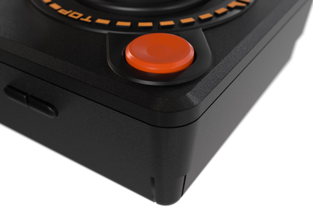Nahaufnahme eines schwarzen Joysticks mit einer orangefarbenen Taste. Das Wort TOP ist aufgedruckt.