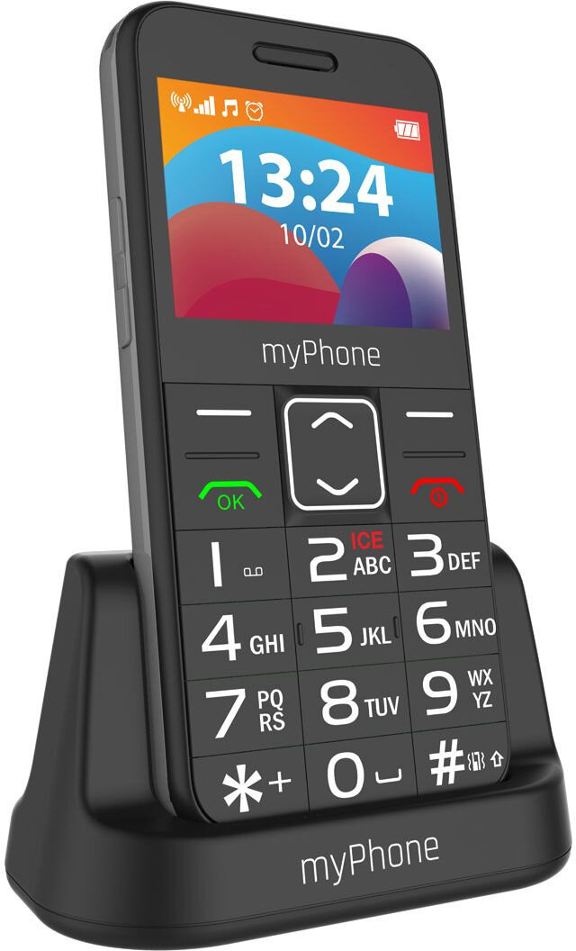 Czarny telefon komórkowy w swojej stacji ładującej. Posiada duże przyciski i duży wyświetlacz.