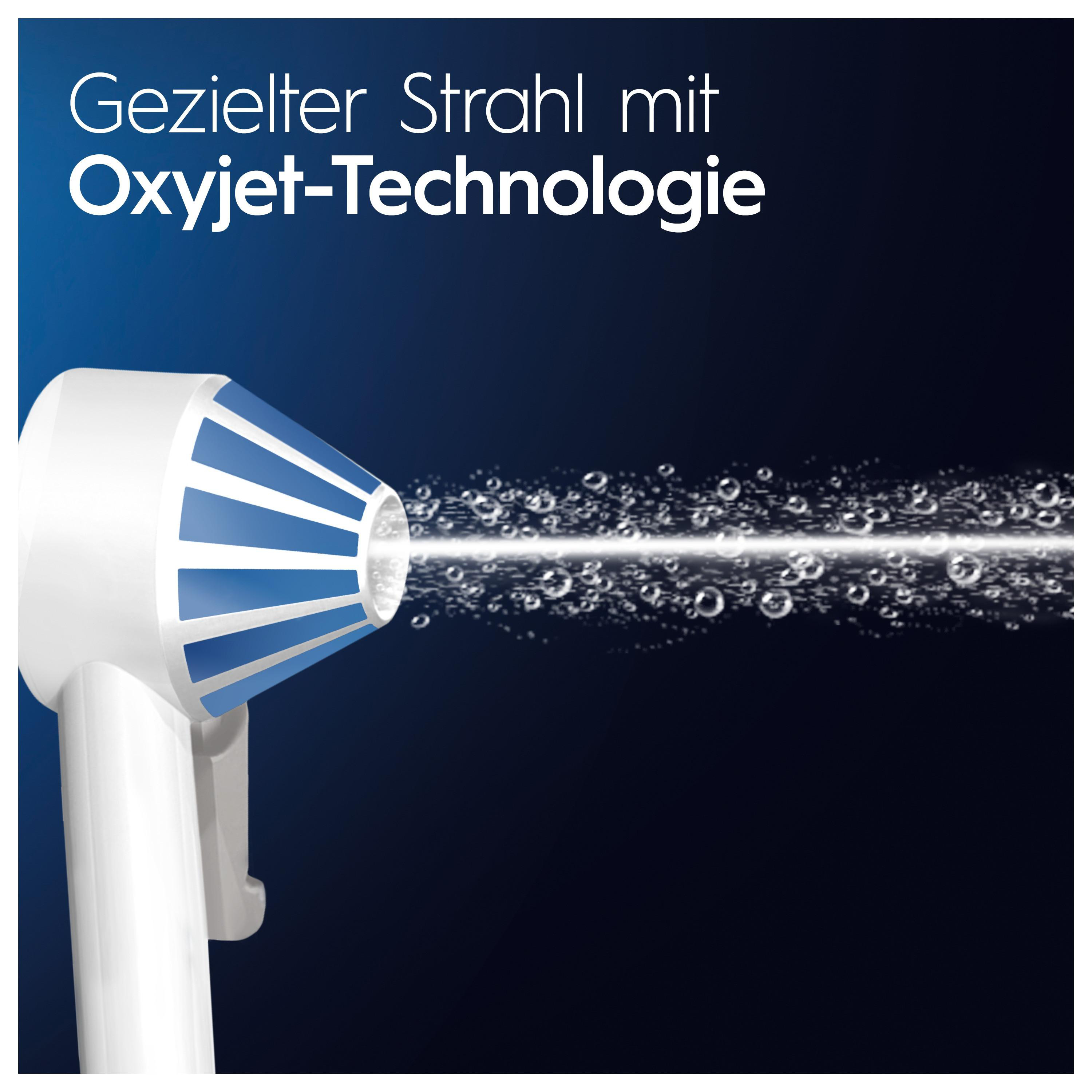 Nahaufnahme eines Oral-B Produkts, mit Wasserstrahl und Blasen.