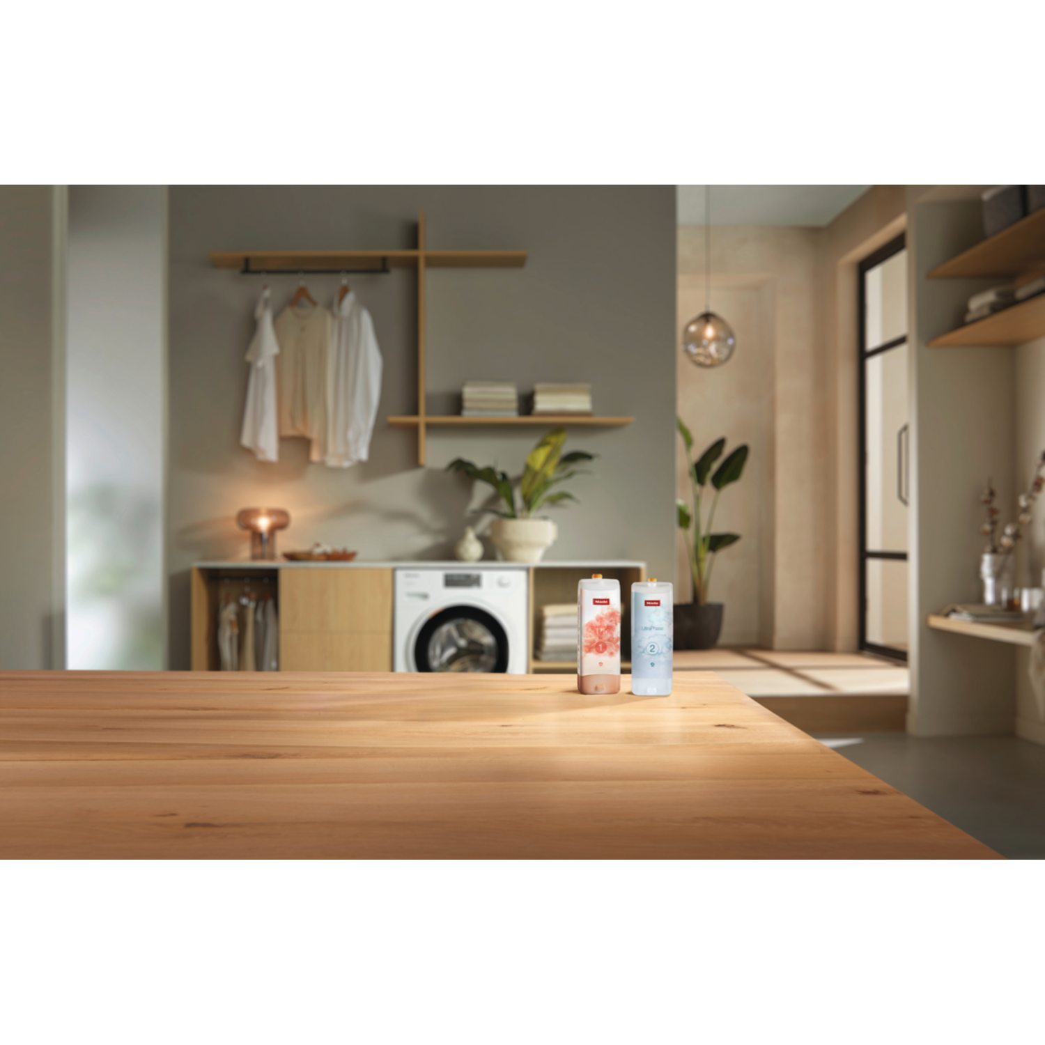 Wooden table with two bottles and laundry room in background. Bright and airy scene.