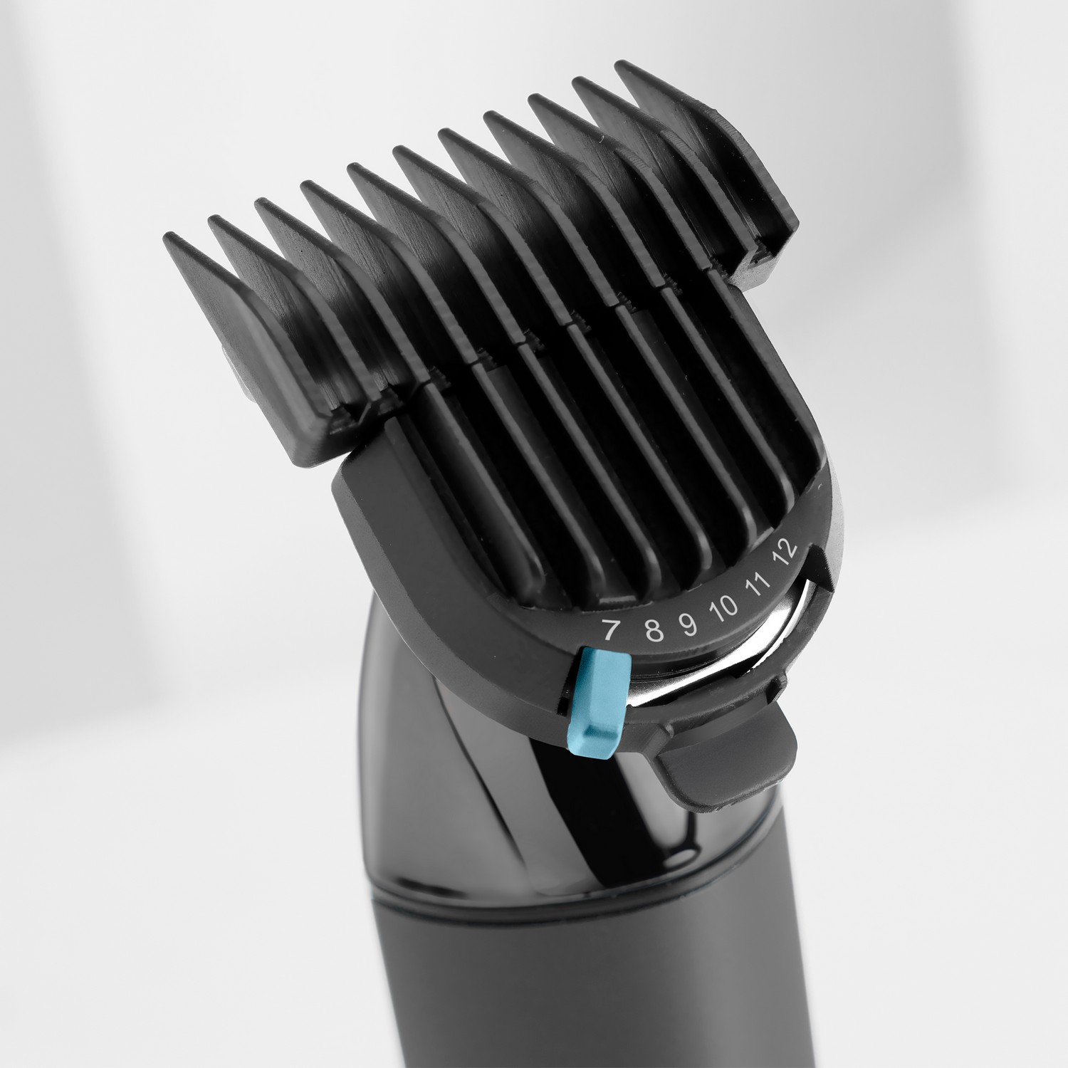 Black hair clipper attachment with adjustable numbers, showing 7, 8, 9, 10, 11, 12.