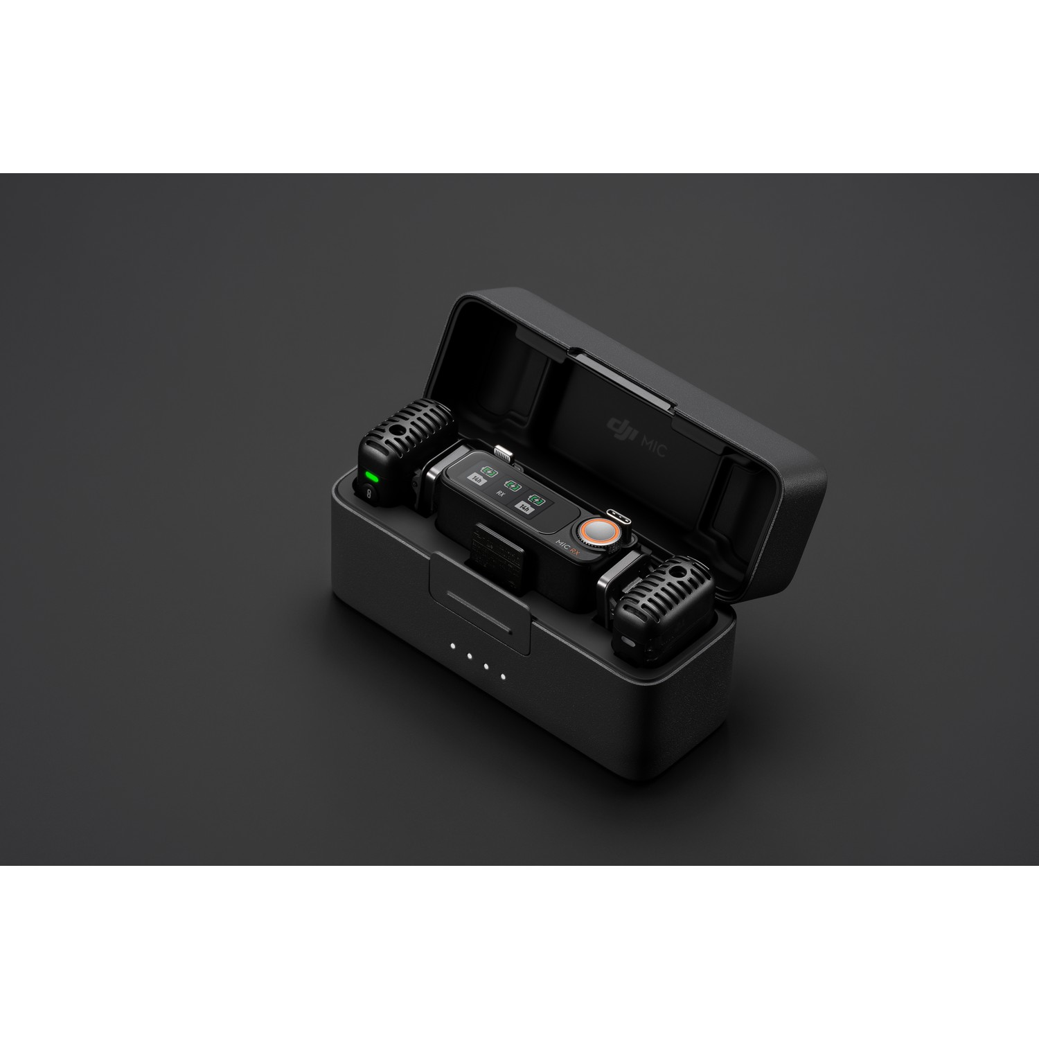A black case containing two microphones and a charging base on a dark surface.
