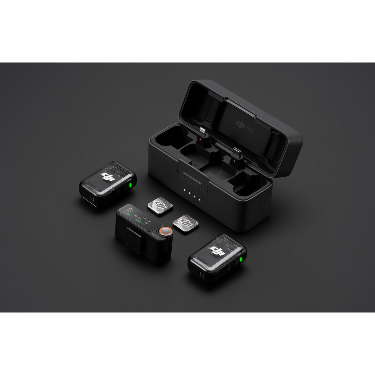 DJI Mic wireless microphone set: 2 mics, a receiver, and a charging case on black surface.