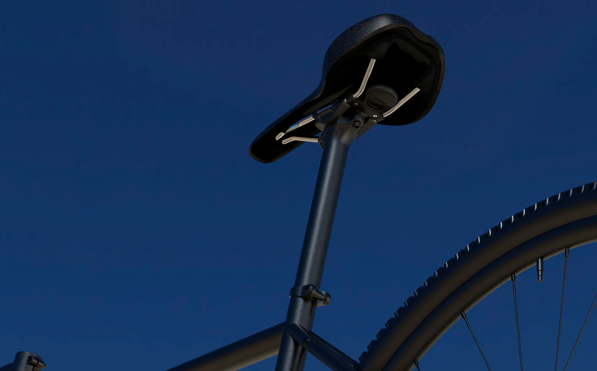 Gros plan d'une tige de selle de vélo noire et d'une partie de la roue arrière sur fond de ciel bleu.