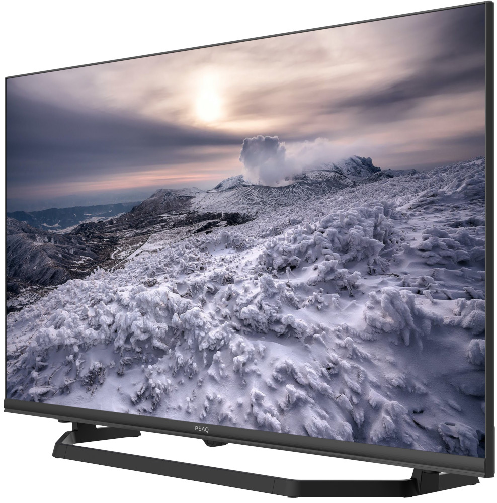 Flat screen TV displaying a snowy mountain scene under a cloudy sky.
