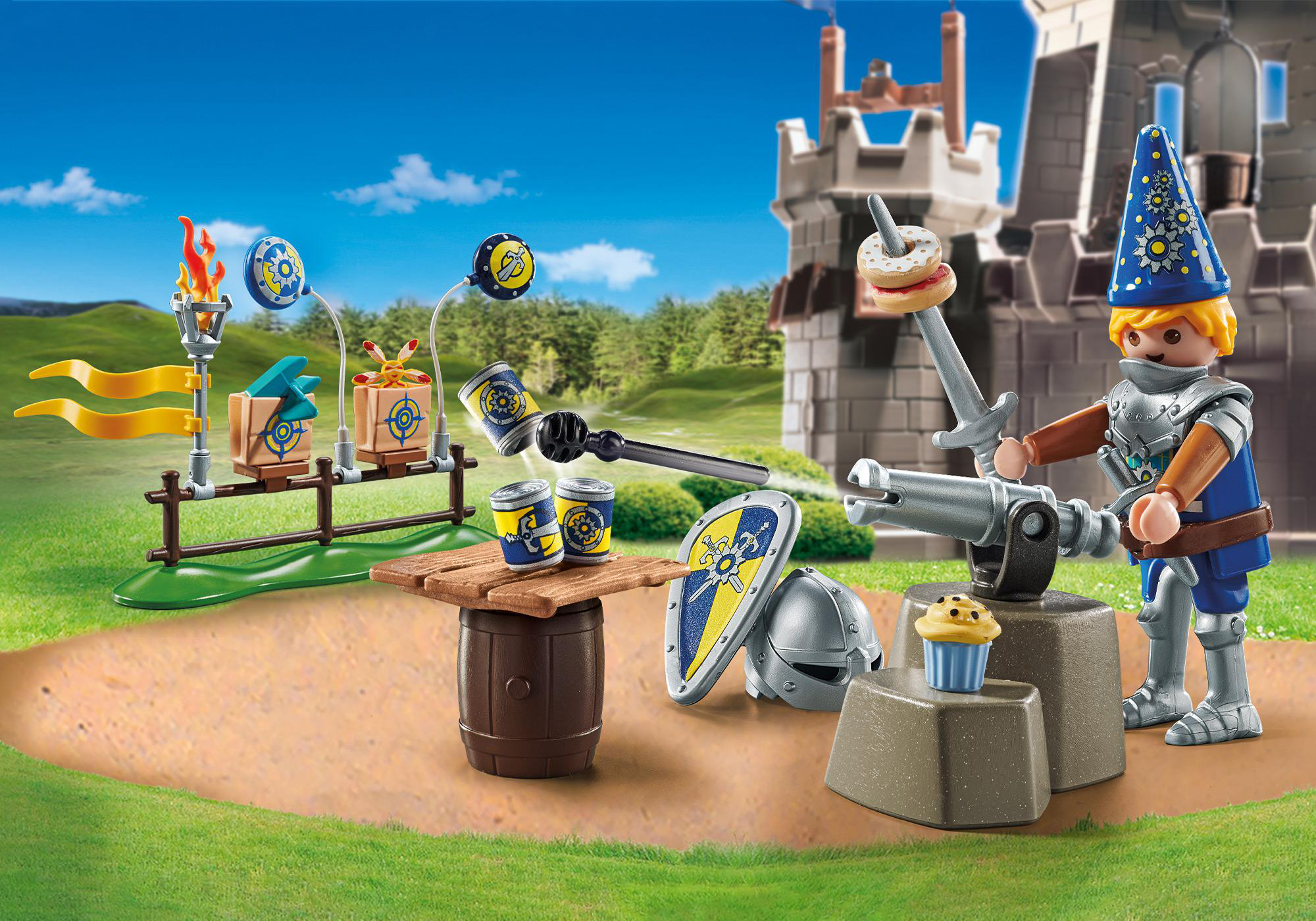 Eine Playmobil-Szene mit einem Ritter, einer Burg und verschiedenen Spielzeug-Lebensmitteln auf einem Tisch.
