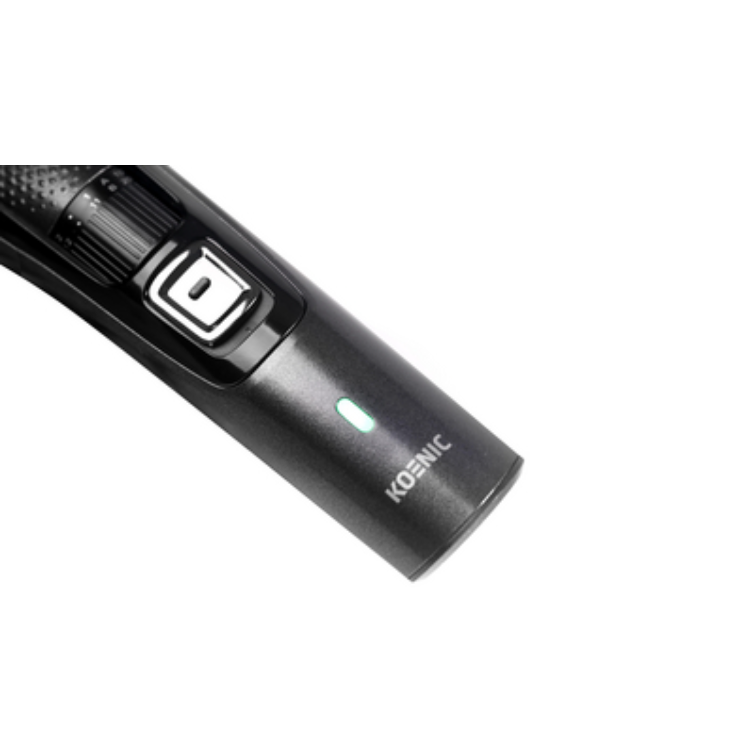 Close-up of black KOENIC hair trimmer. Green light active. White background.