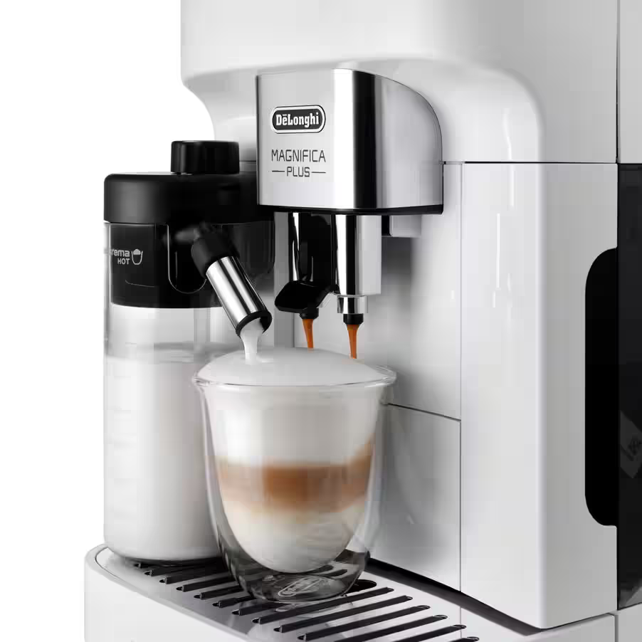 Fehér és ezüst eszpresszó gép, egy üvegpohárral, amely latte-val van tele.
