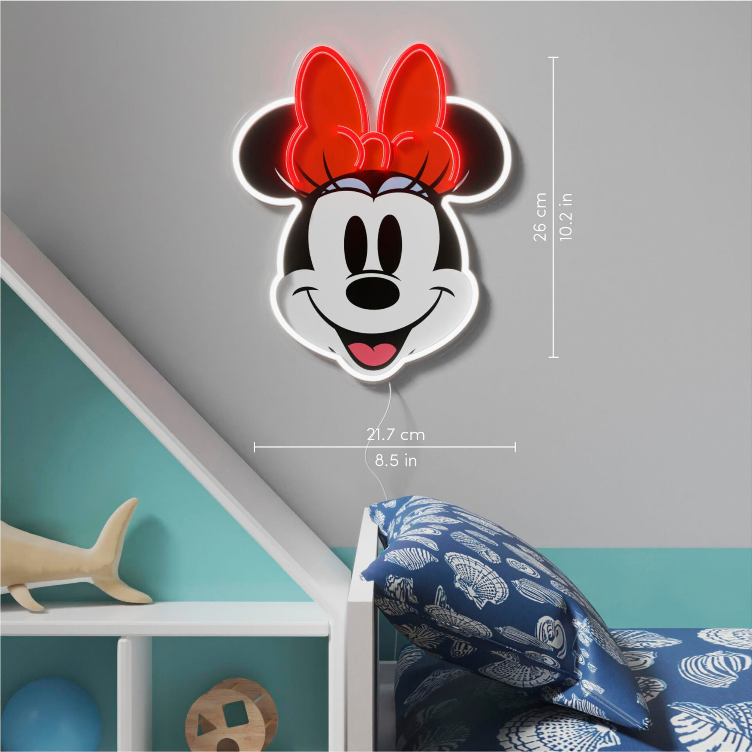Eine Minnie Mouse-förmige Neonleuchte vor einer grauen Wand, mit Abmessungen in cm und Zoll.