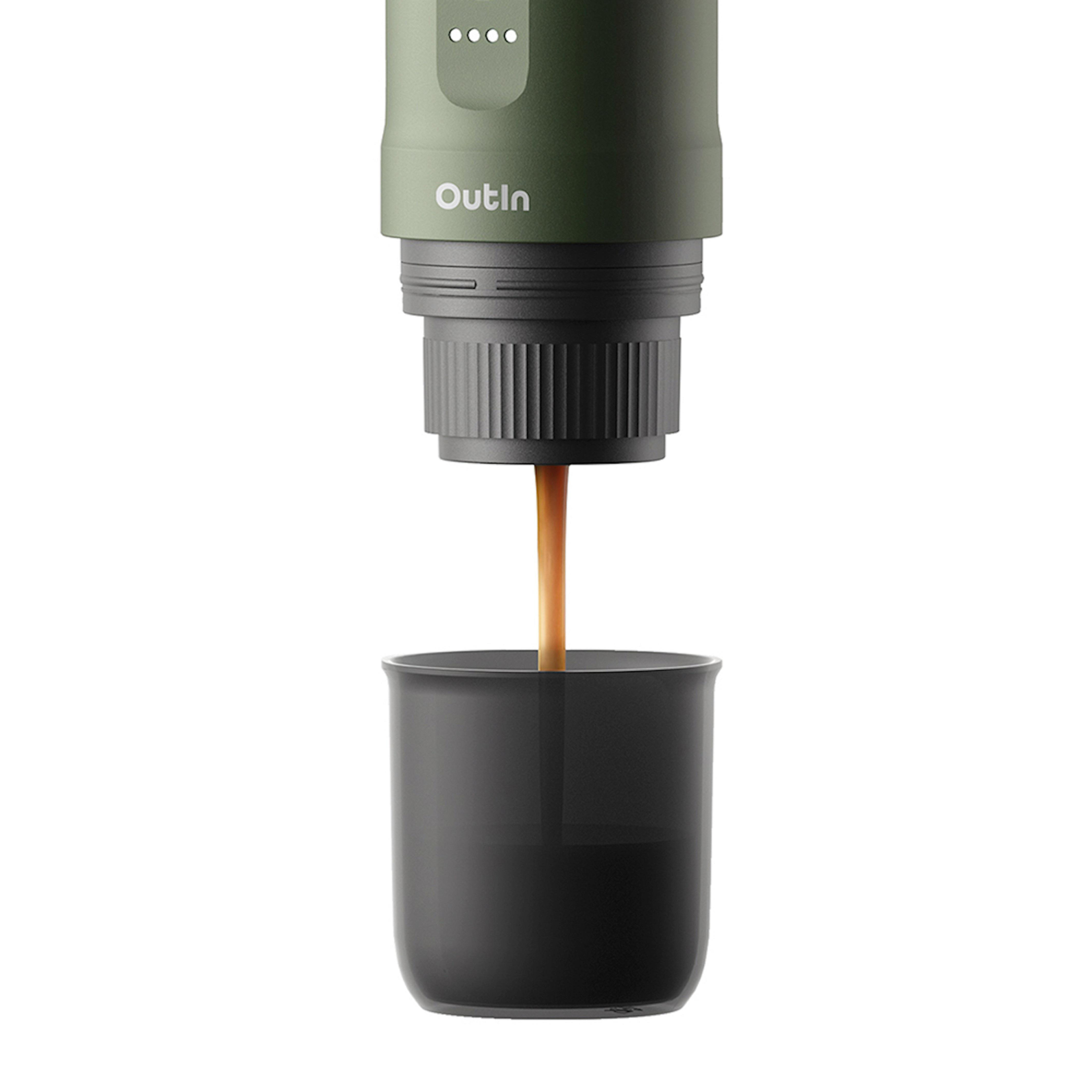 Ein dunkelgrüner Outin-Kaffeezubereiter, der Kaffee in eine schwarze Tasse ausgibt. Weißer Hintergrund.