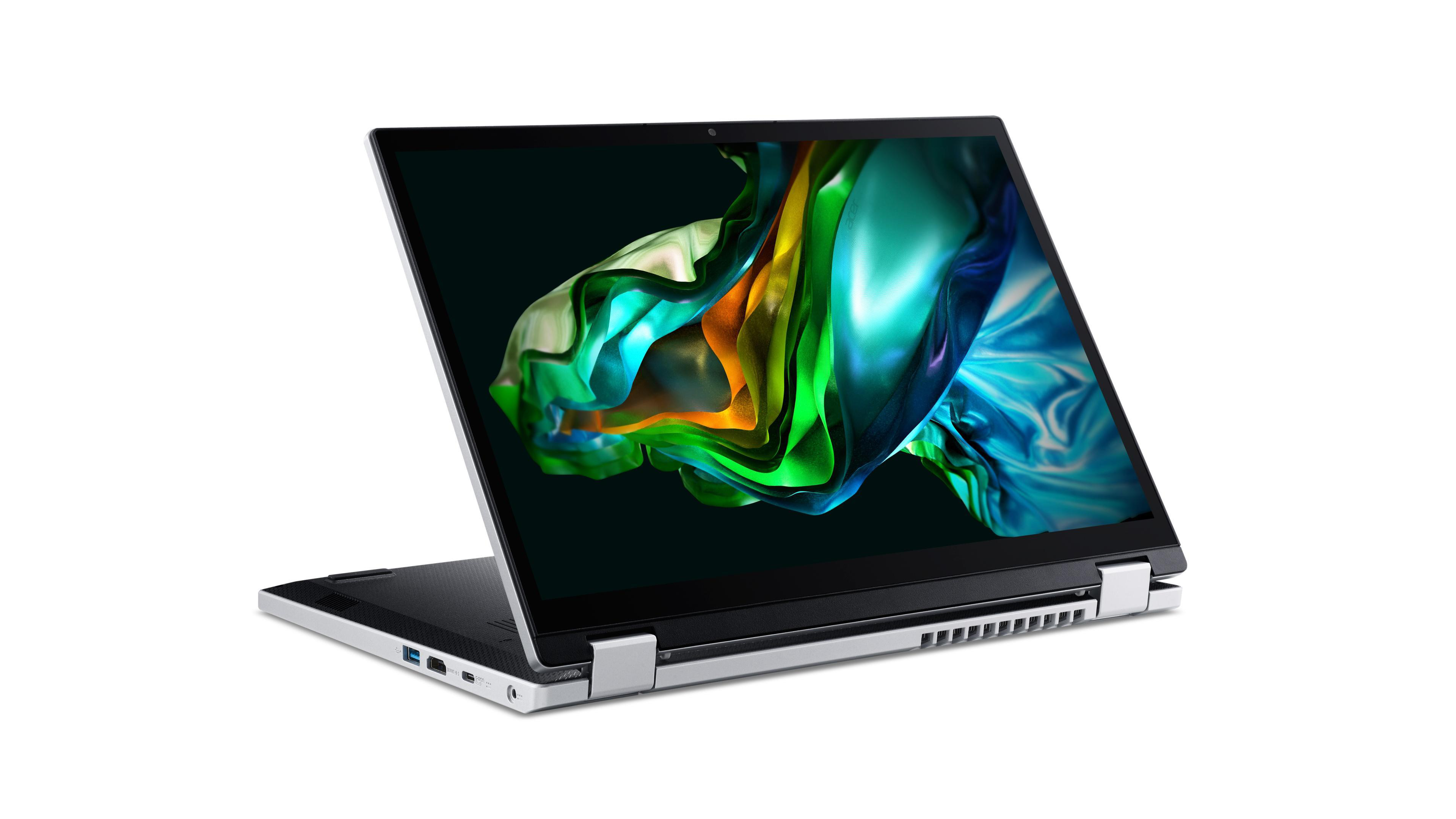 Ein silberner Laptop mit einem schwarzen Bildschirm, der farbenfrohe Formen zeigt.