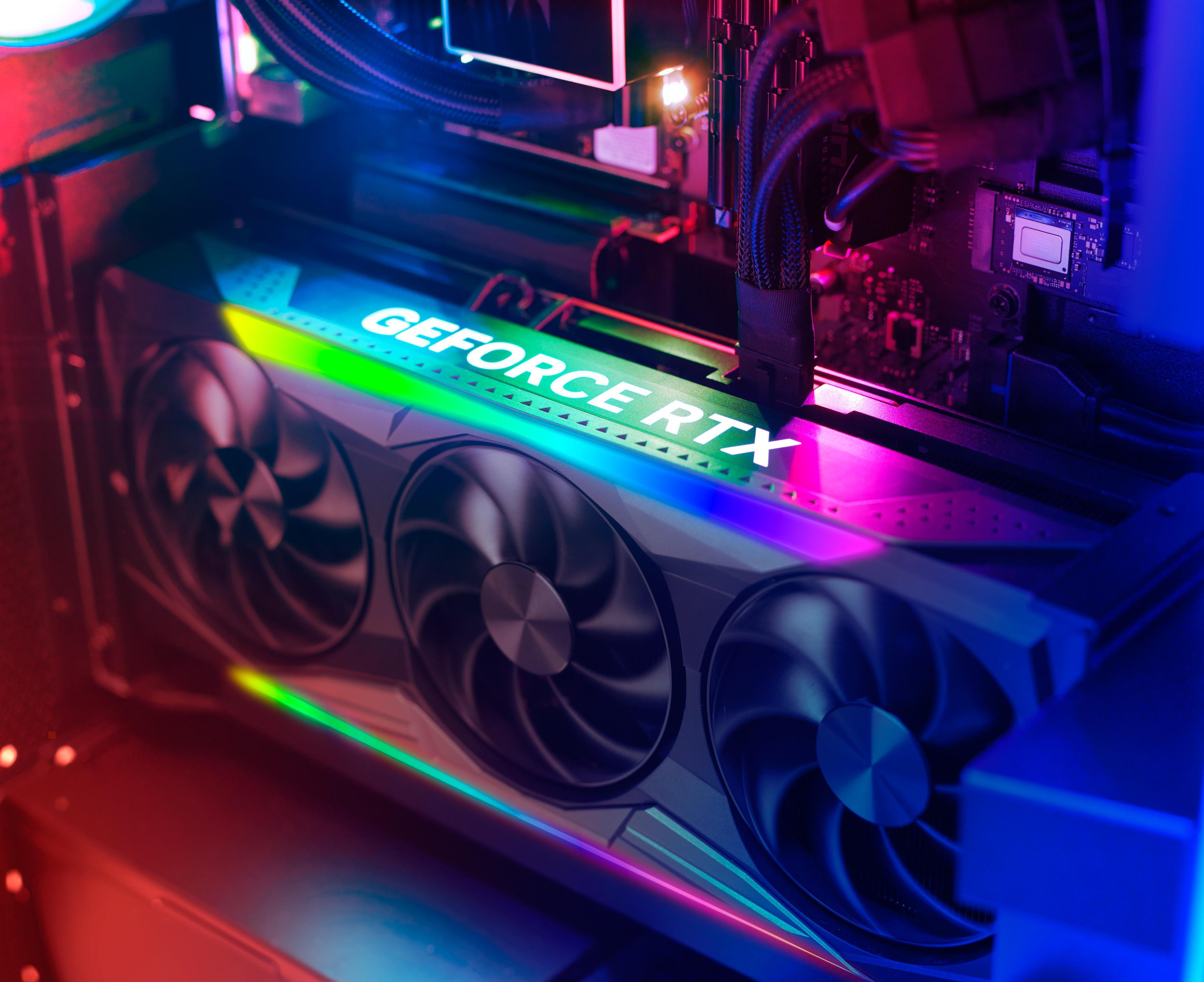 Nahaufnahme einer Grafikkarte mit dem Text 'GEFORCE RTX' und Lüftern.