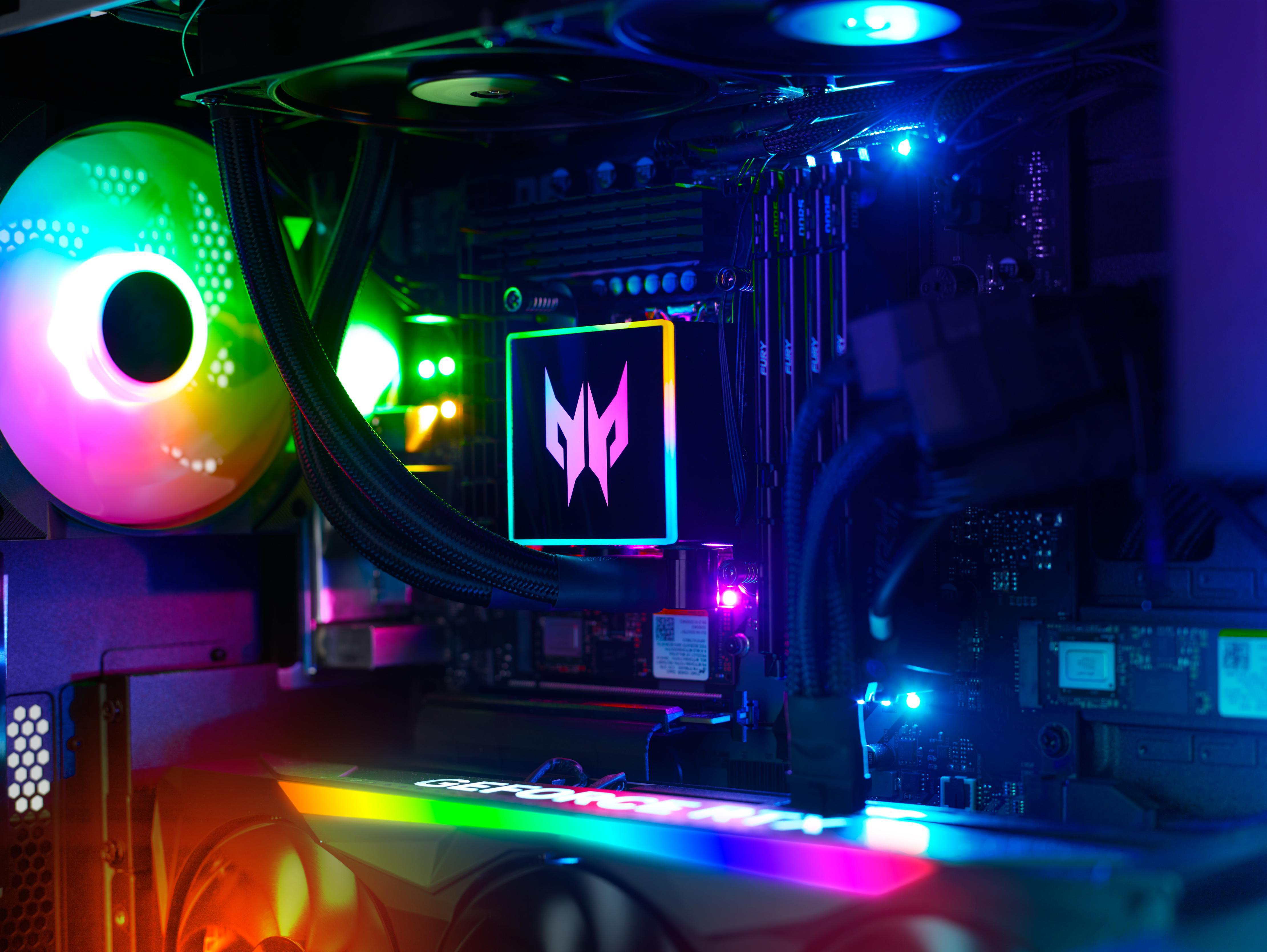 PC-Inneres mit farbenfroher Beleuchtung, CPU- und GPU-Komponenten und leuchtendem Logo.