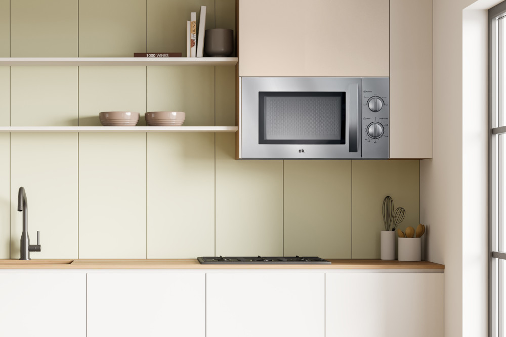 Kitchen with microwave. Microwave above a gas hob, shelves above. Beige and green walls.