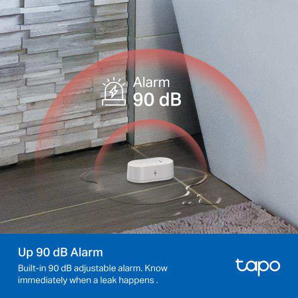 Wassersensor auf Fliesenboden. Roter Alarmbogen wird angezeigt. Text gibt an, dass der Alarm 90 dB beträgt.