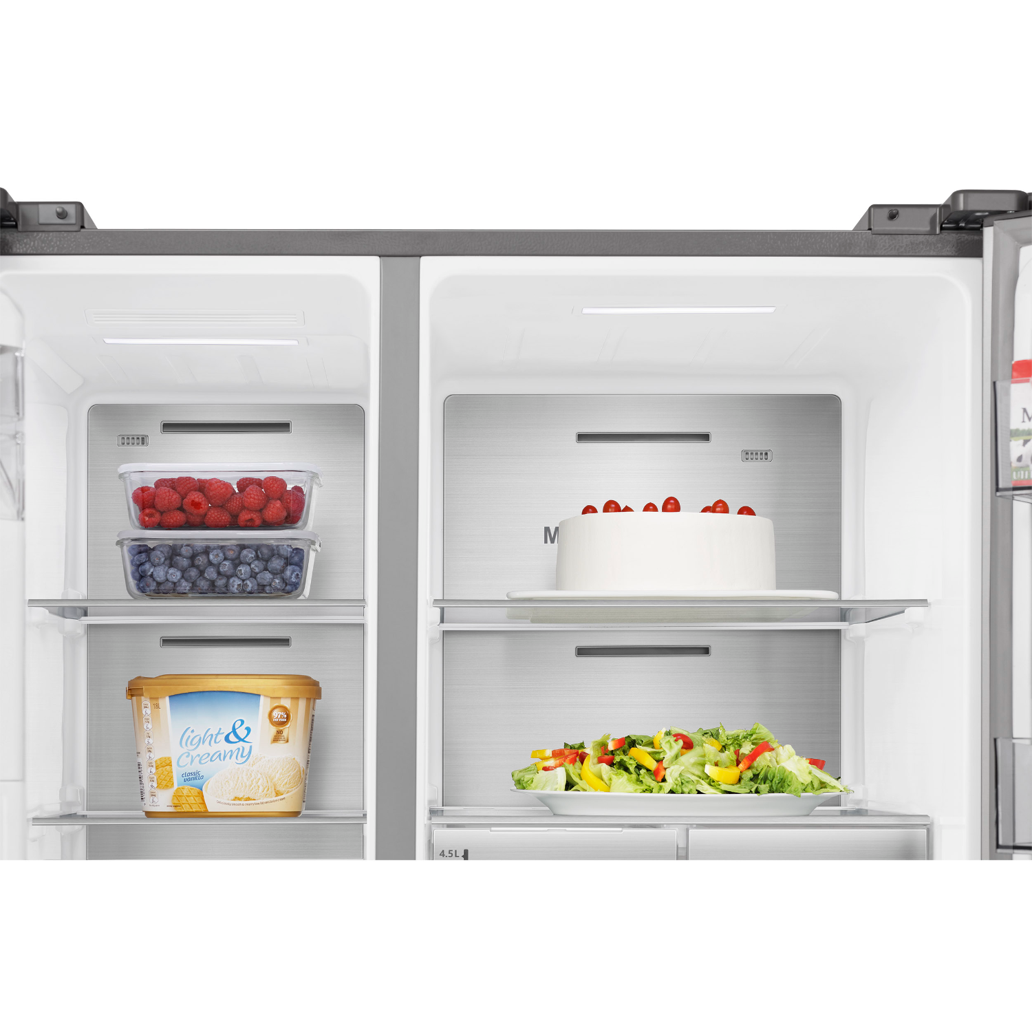 Fridge interior with two shelves. One with berries and another with cake and salad.