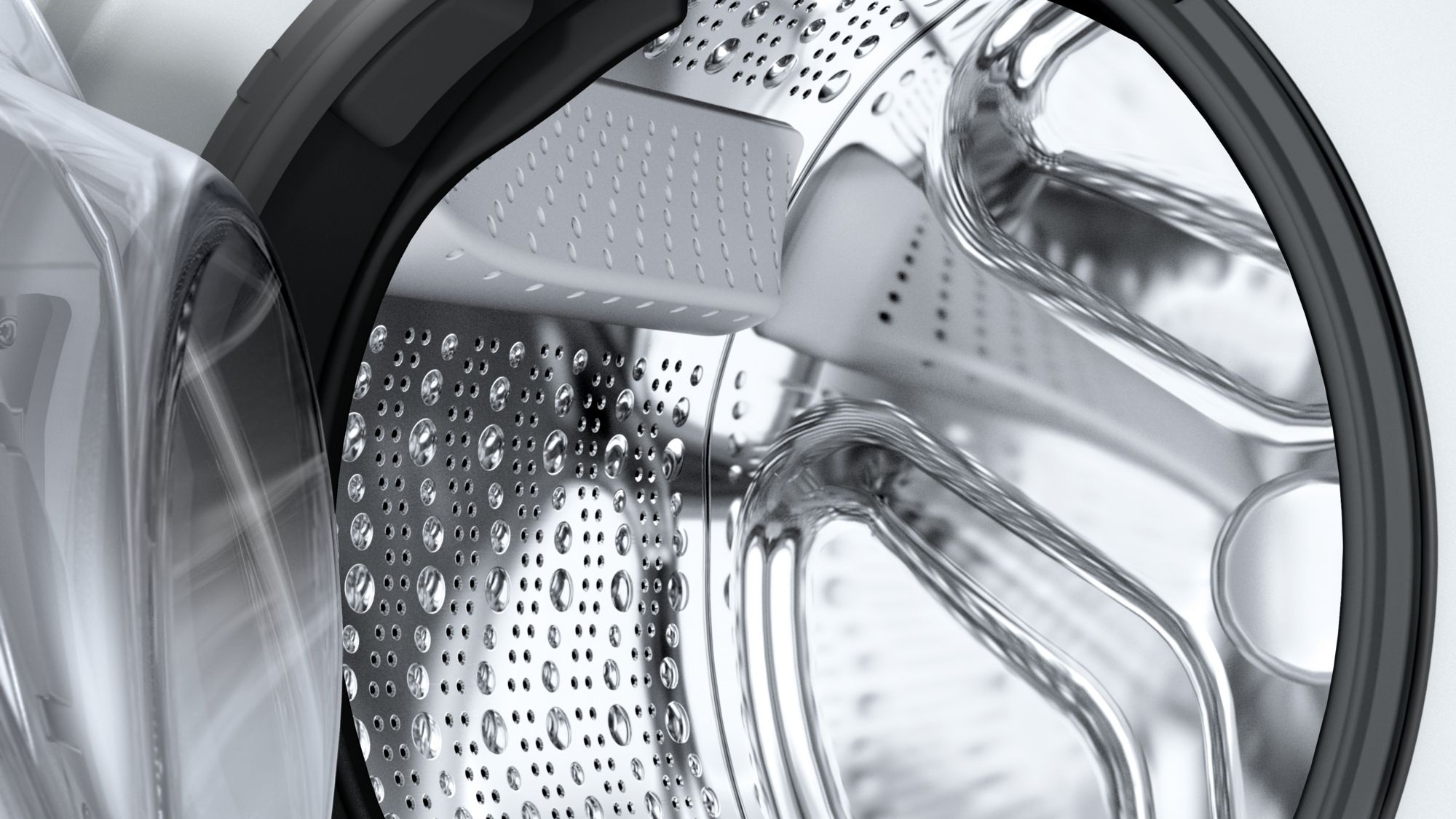 Intérieur du tambour de la machine à laver. Acier inoxydable. Design perforé. Aspect propre et métallique.