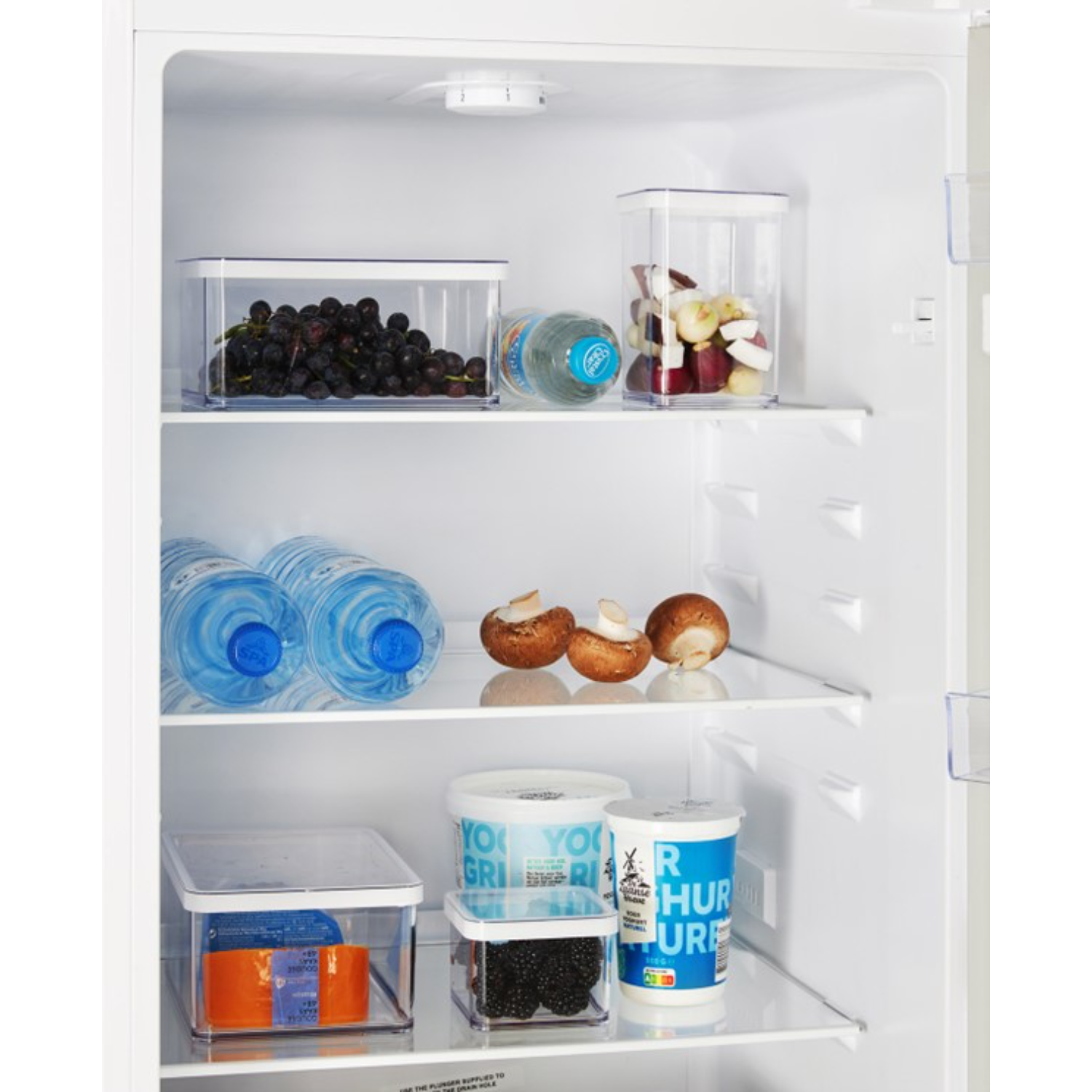Refrigerator interior with shelves holding food items.