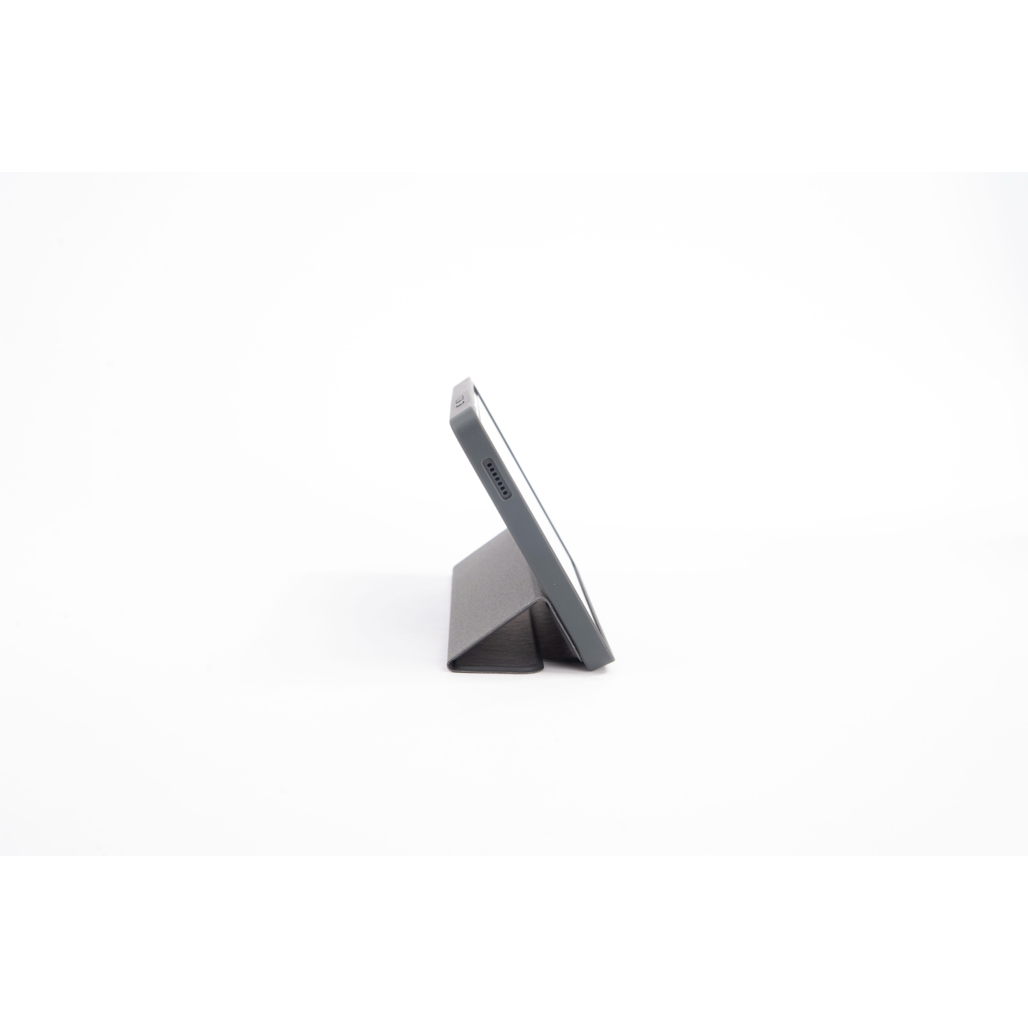 A grey tablet in a case, propped up for viewing, against a white backdrop, showcasing its profile.