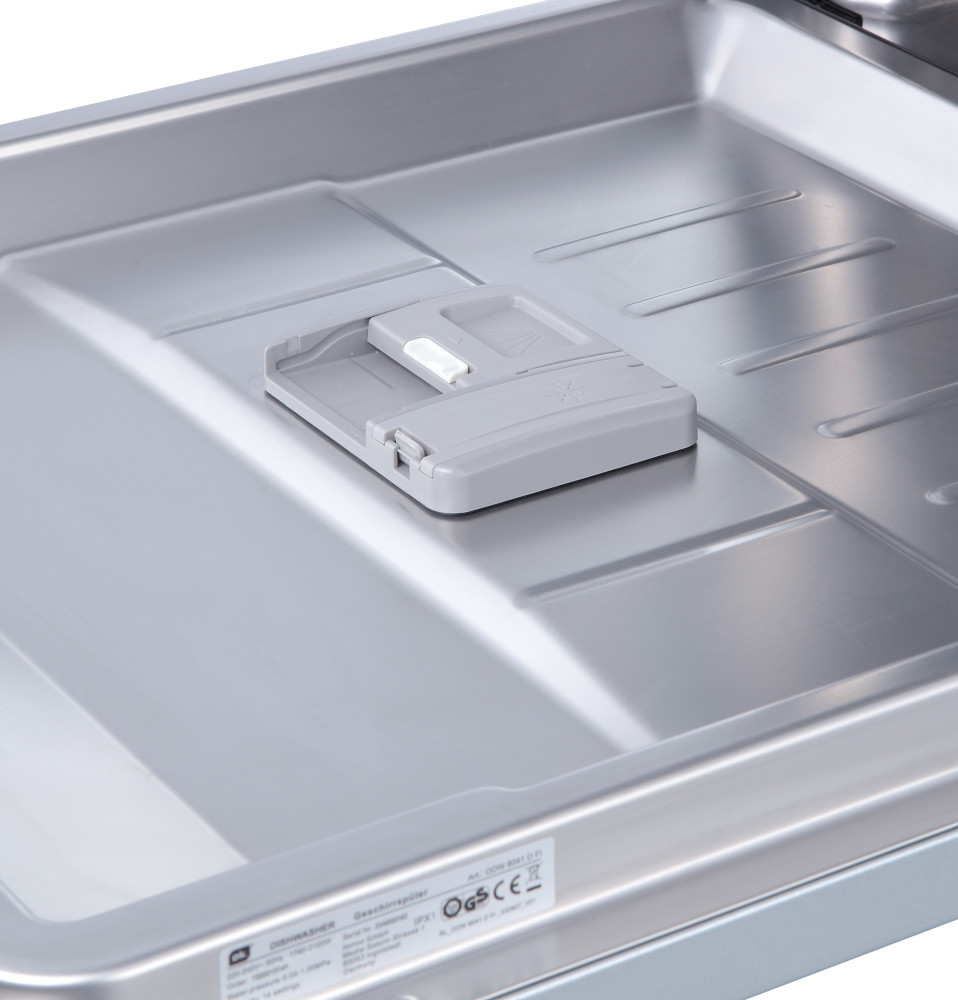 A dishwasher's soap dispenser with a tablet in it.