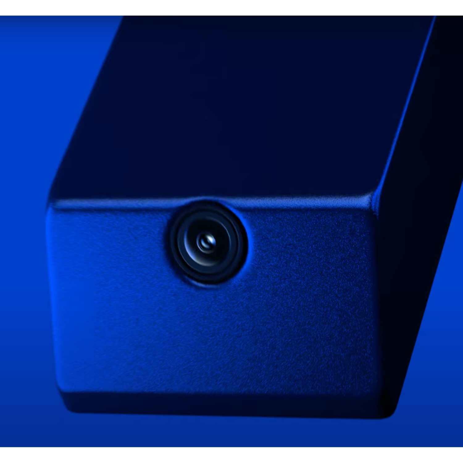 Close-up of a dark blue device with a circular camera lens.