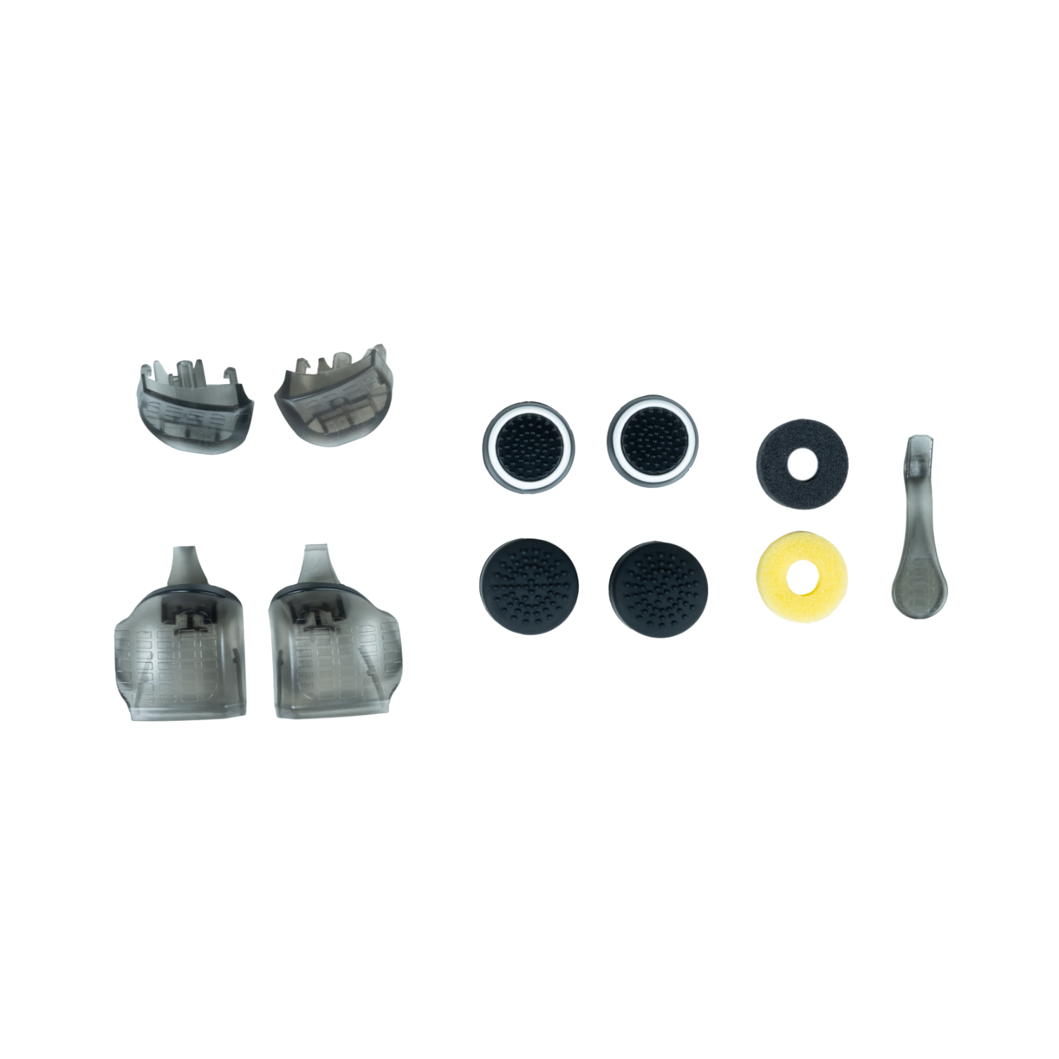 Game controller accessories, including joysticks, buttons, and other parts, on a white surface.