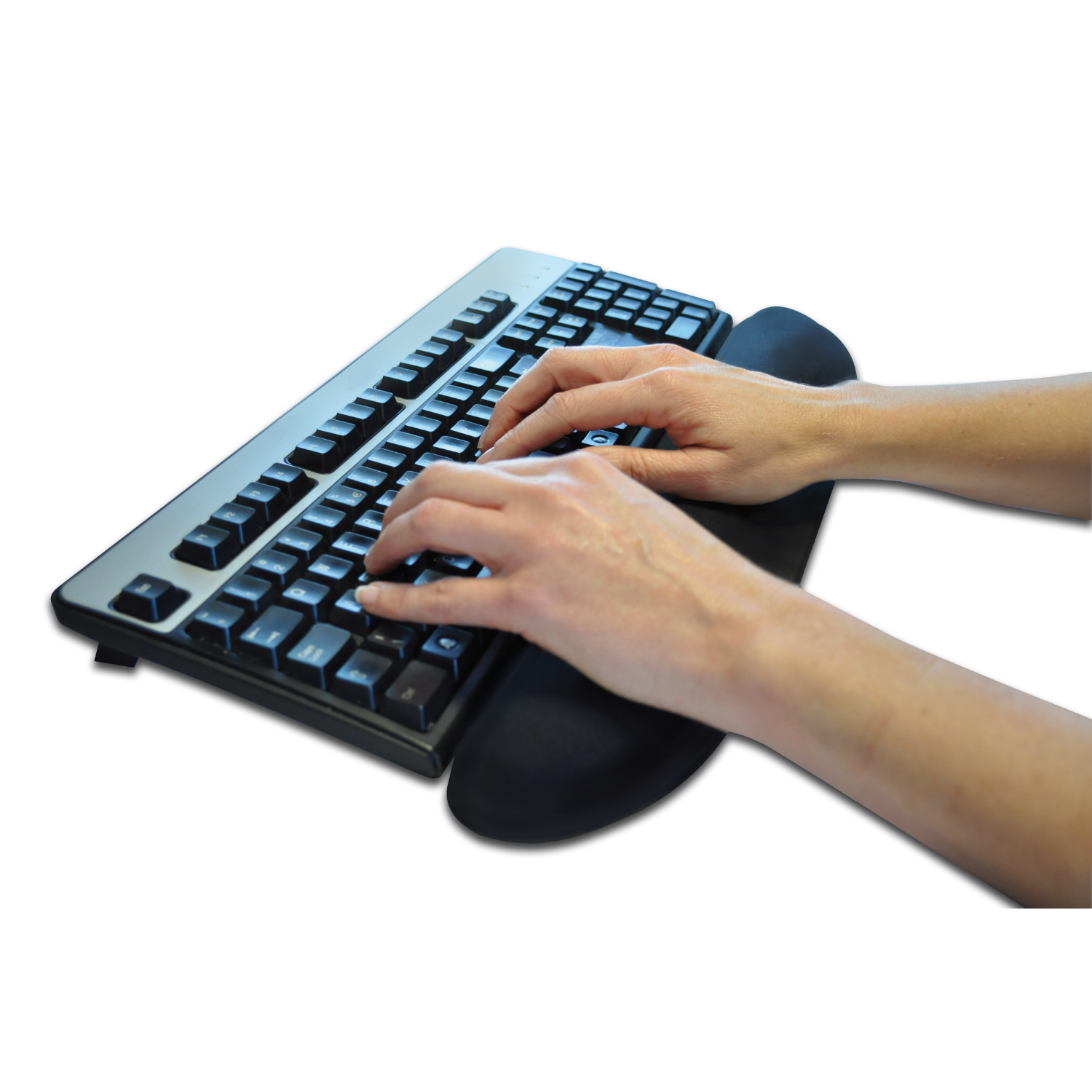 Hands typing on a black and silver keyboard with a wrist rest. White background.