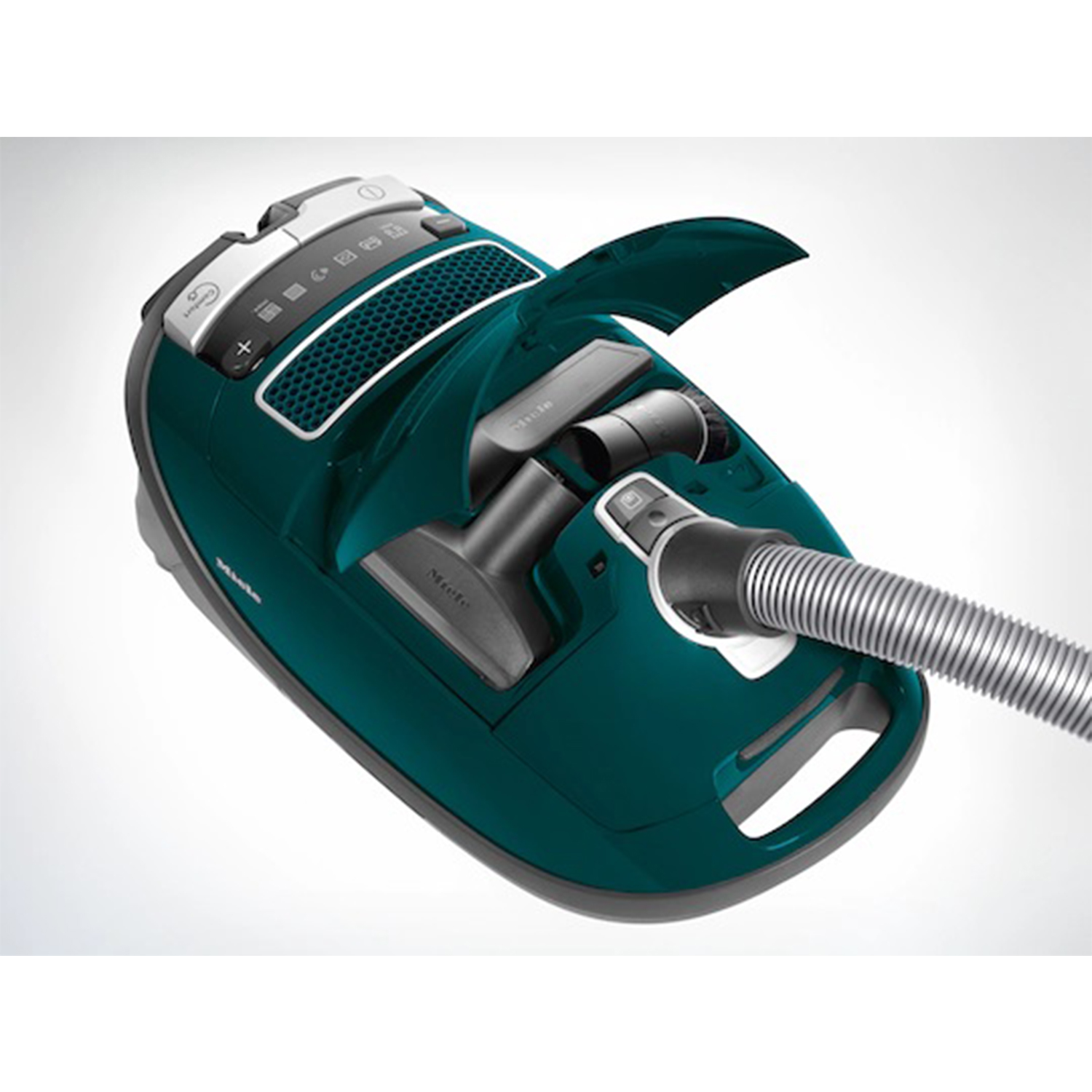 Aspirapolvere verde acqua con tubo e accessori. Il coperchio è aperto per rivelare più accessori.