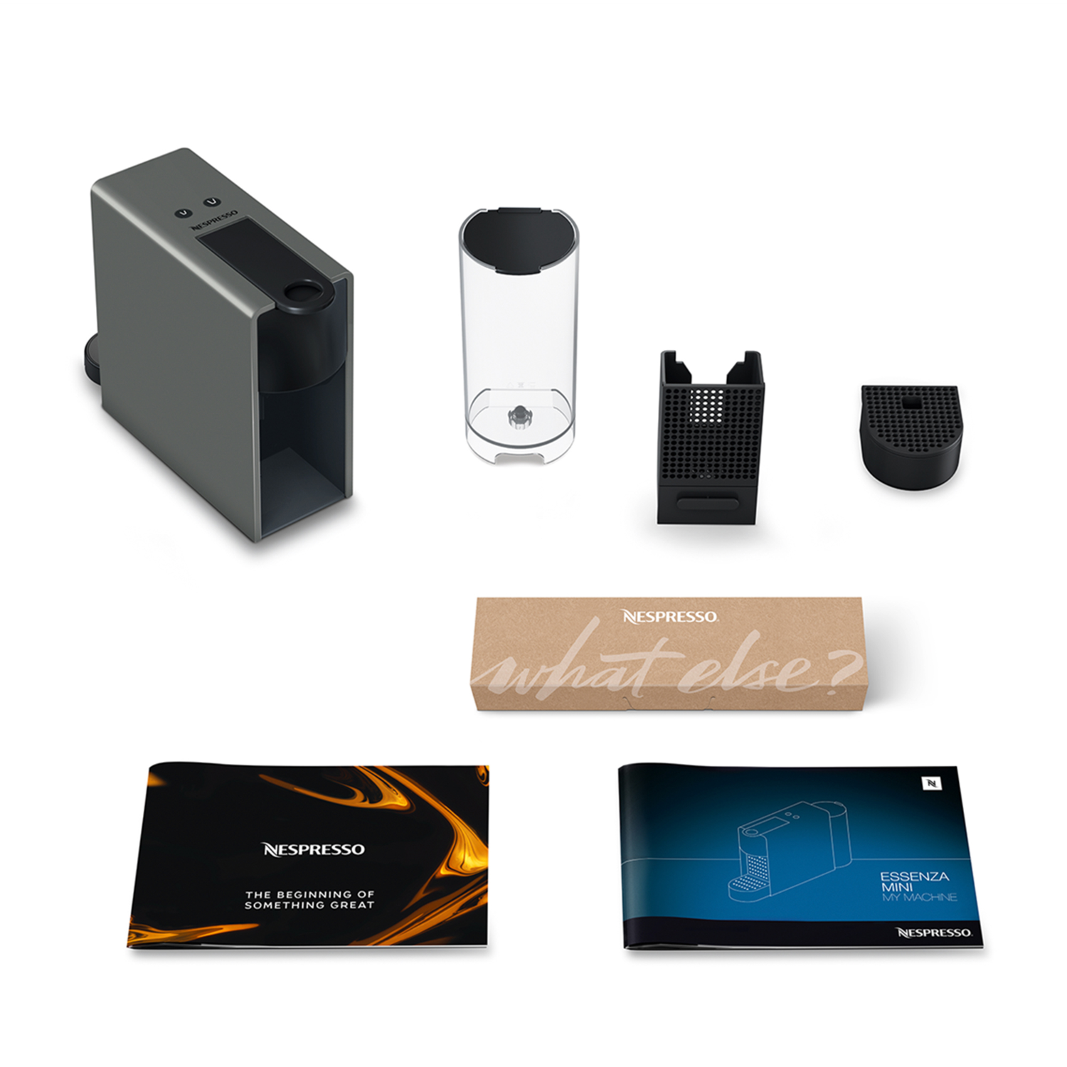 Various parts of a Nespresso coffee machine are spread out, along with instructions and a box.