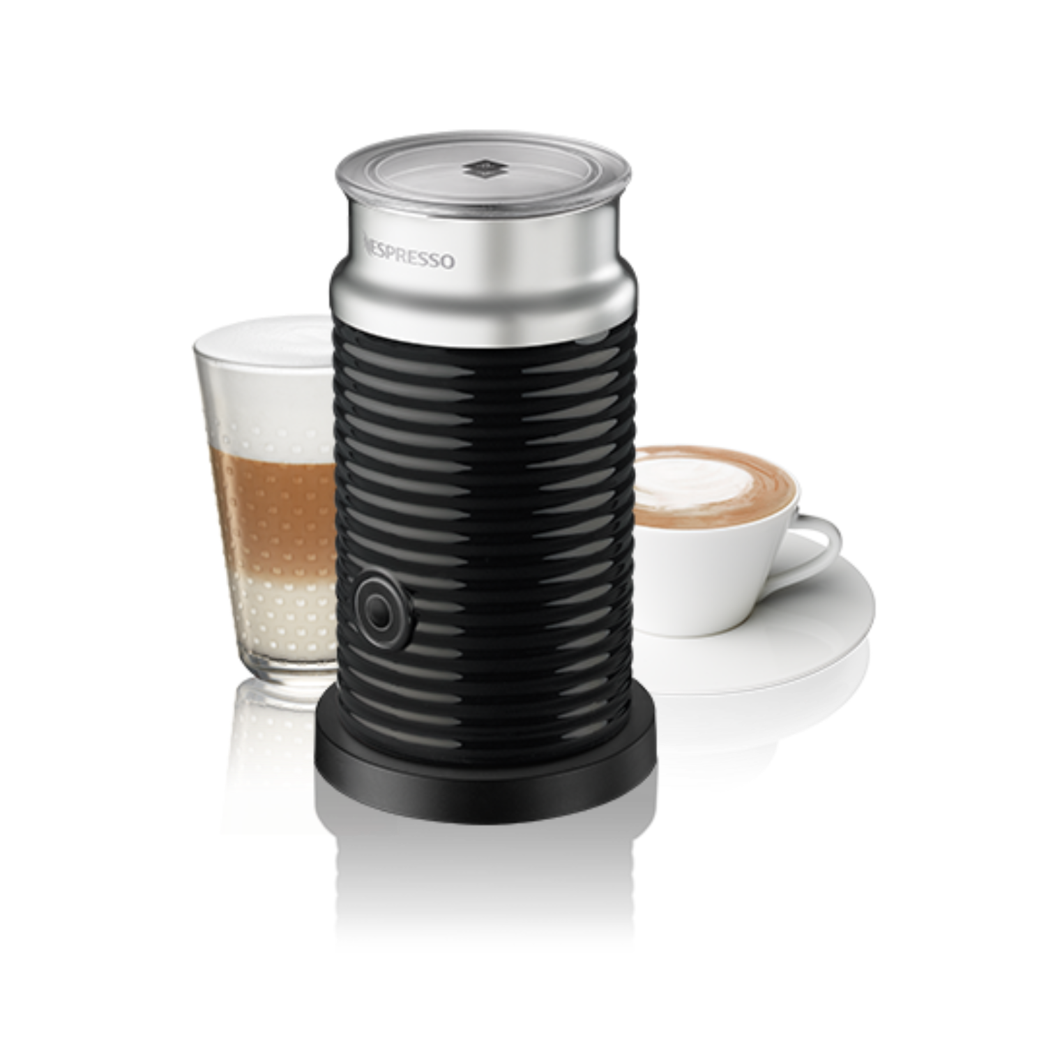 Black and silver Nespresso milk frother with latte art on the left and cappuccino on the right.