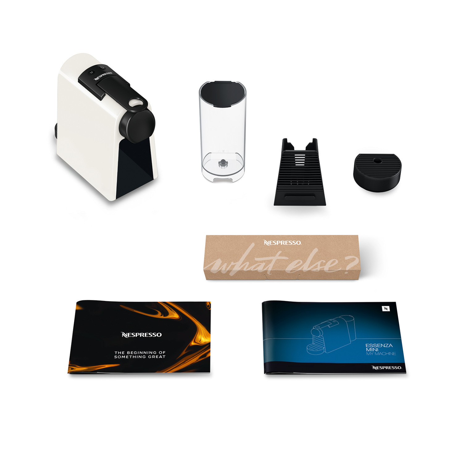 Nespresso-apparaat met accessoires. Witte machine, zwarte onderdelen en instructies.
