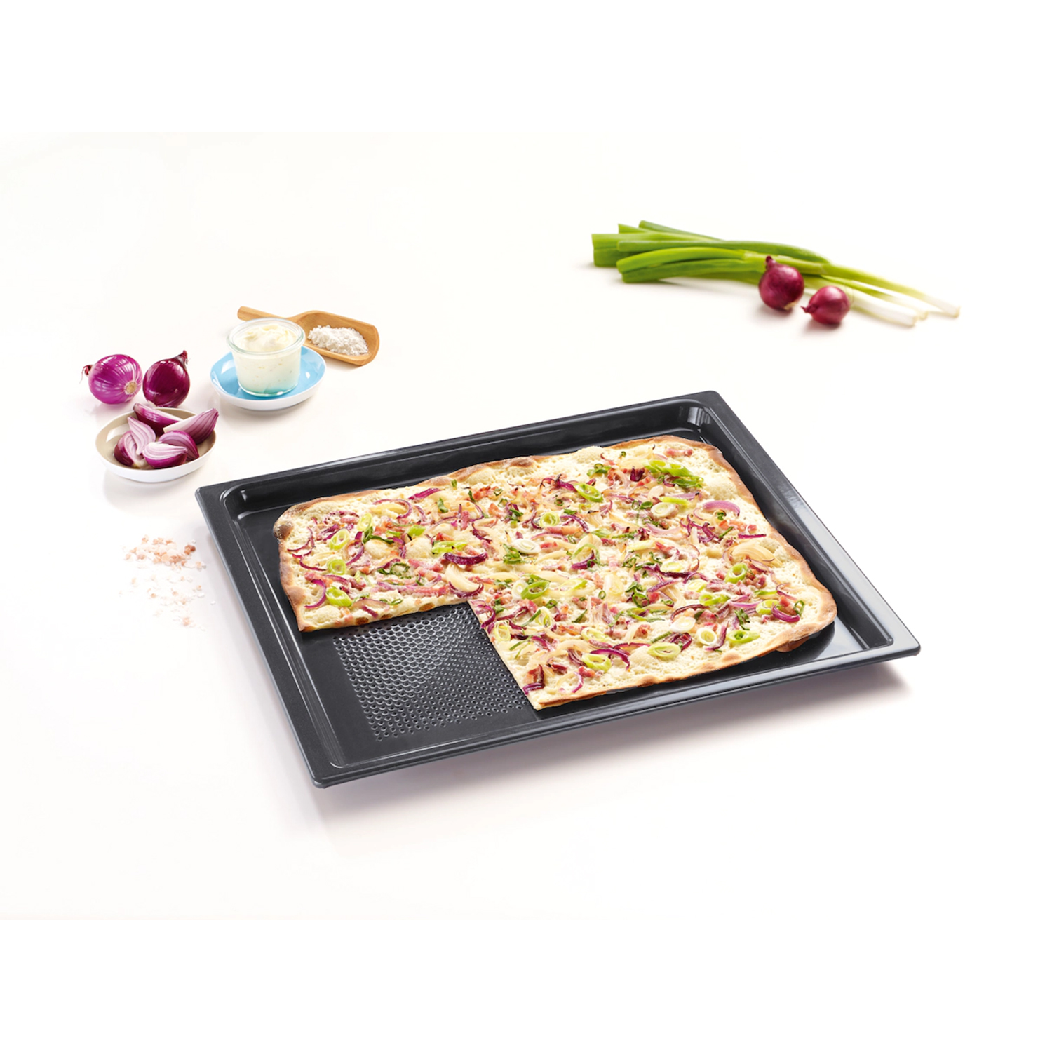 Pizza su un vassoio. La pizza ha condimenti ed è tagliata. Cipolle rosse e altri elementi.