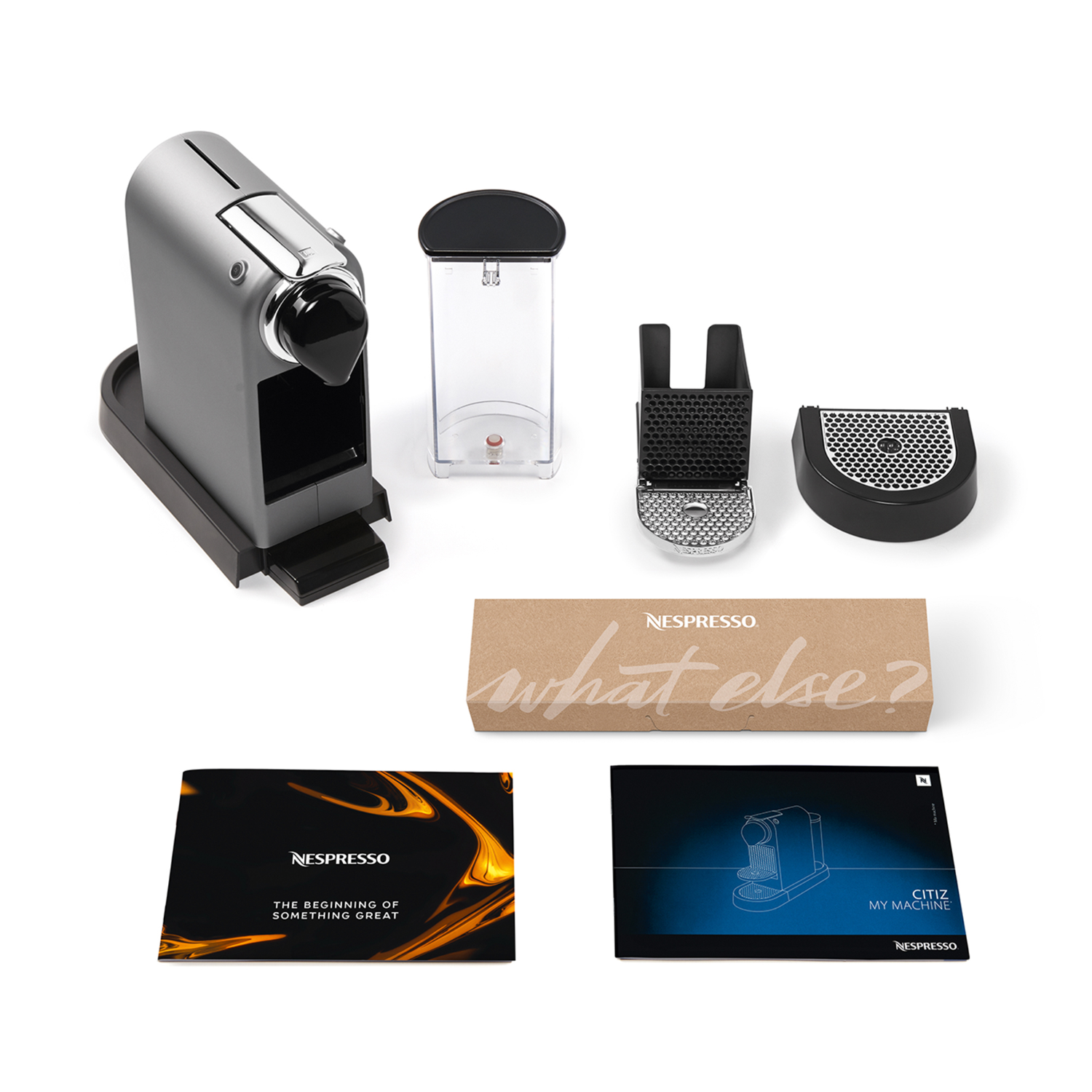 Nespresso machine parts, including a machine, water tank, and accessories.