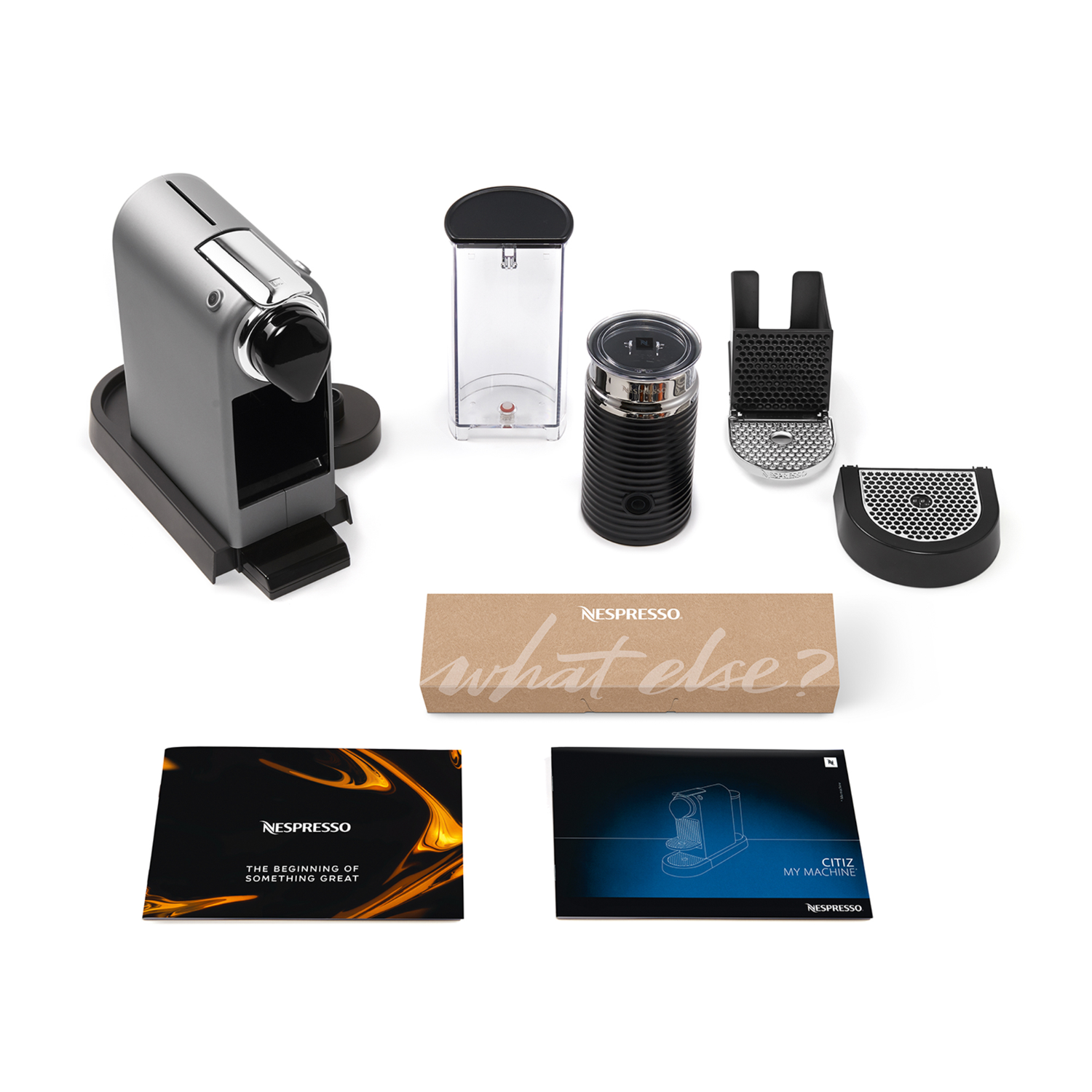 A Nespresso coffee machine with various components displayed on a white surface.