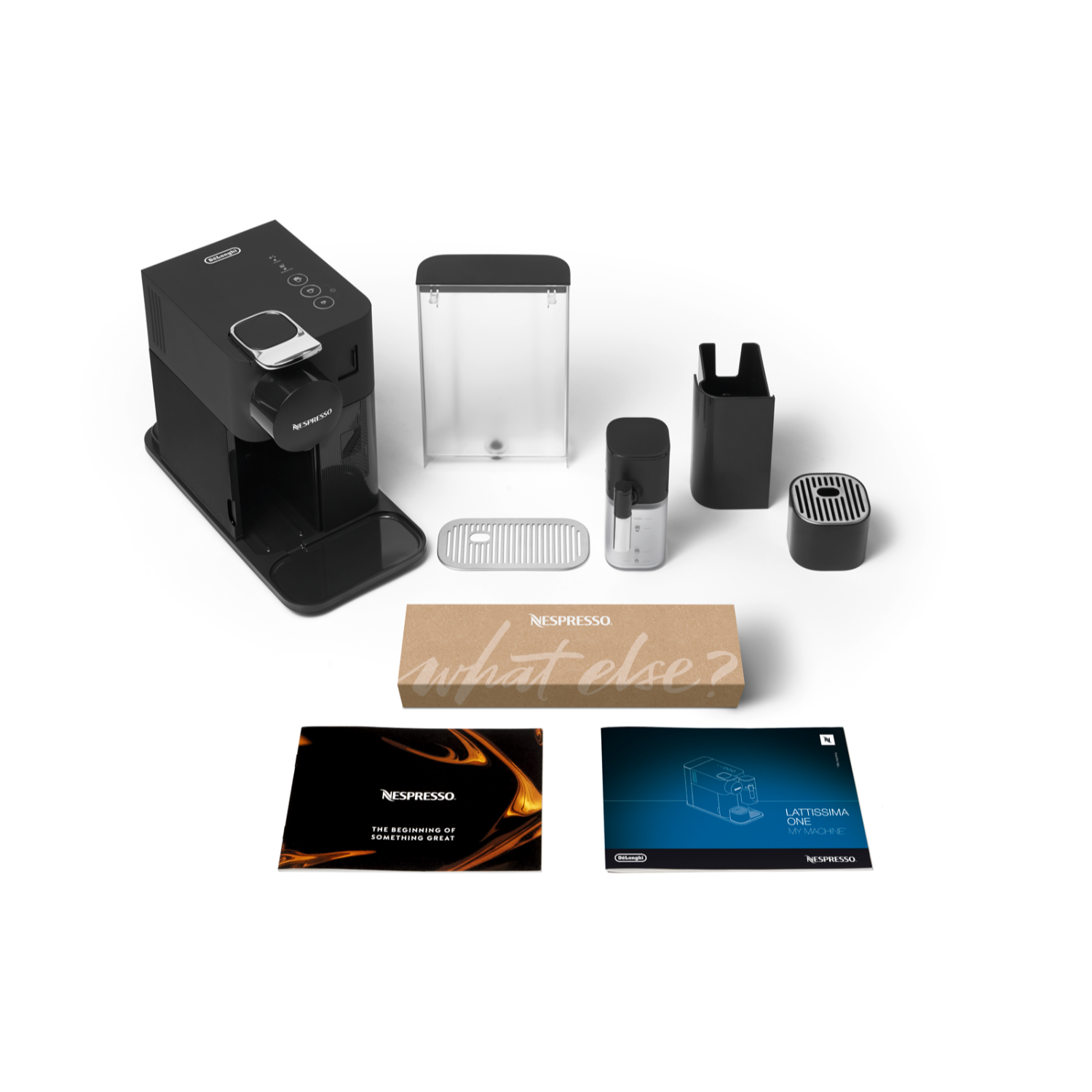 Nespresso coffee machine and accessories arranged on a white surface.