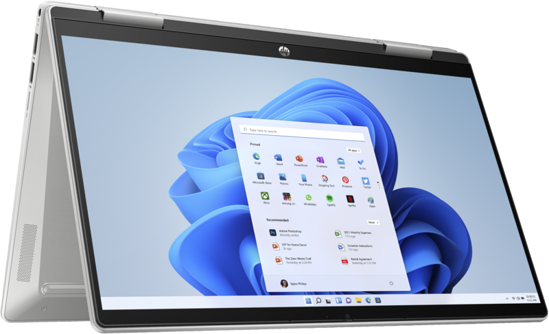 Ezüst laptop Windows 11 felülettel. Stúdió környezetben van.