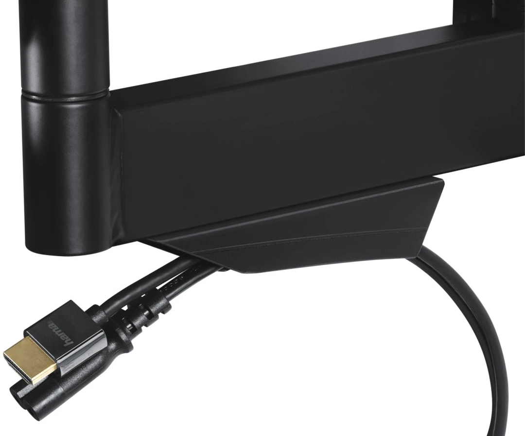 Fekete TV tartókar HDMI kábelekkel. Kábelek a tartóhoz csatlakoznak, fehér falon.