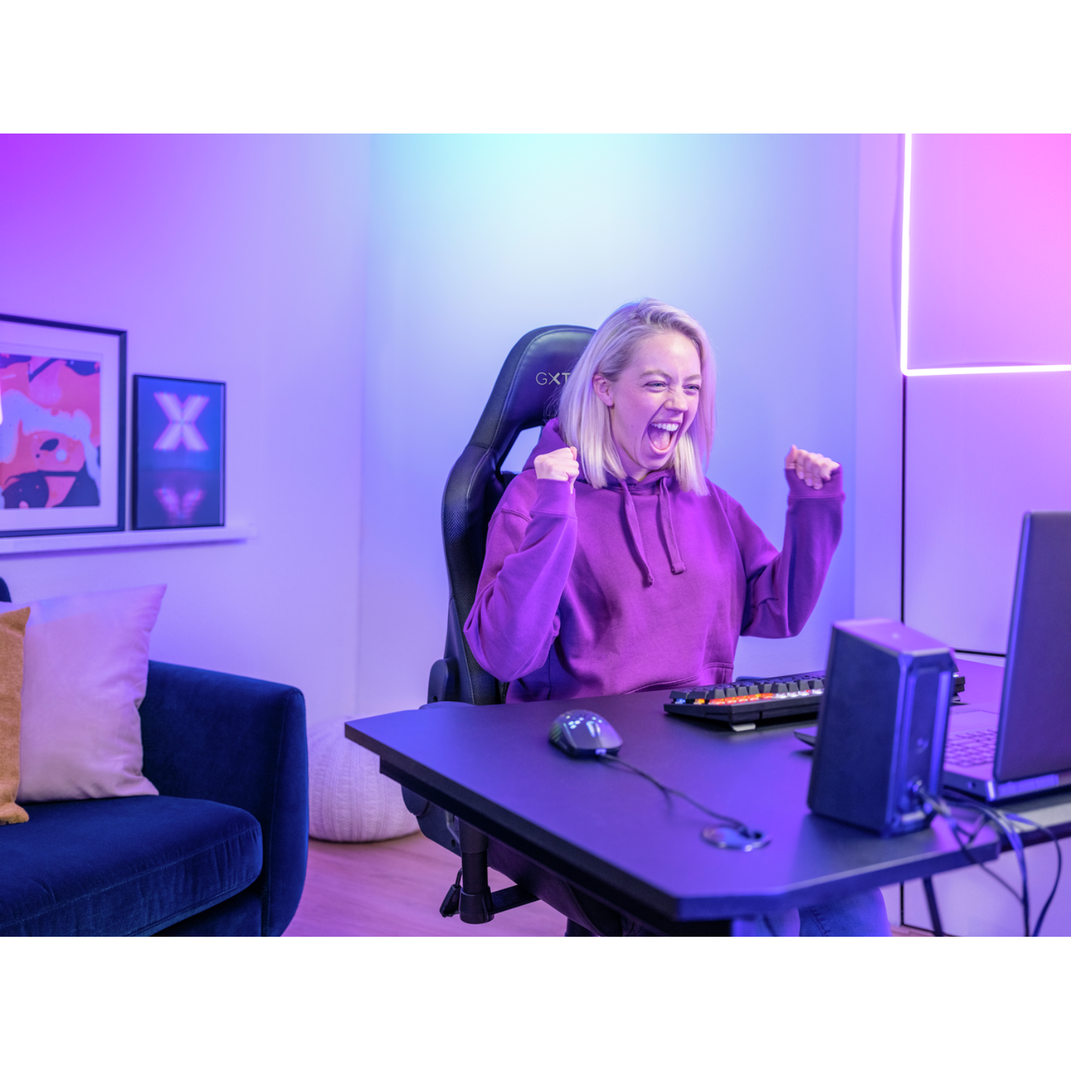 Woman gaming, celebrating a victory. Excited face, hands up.