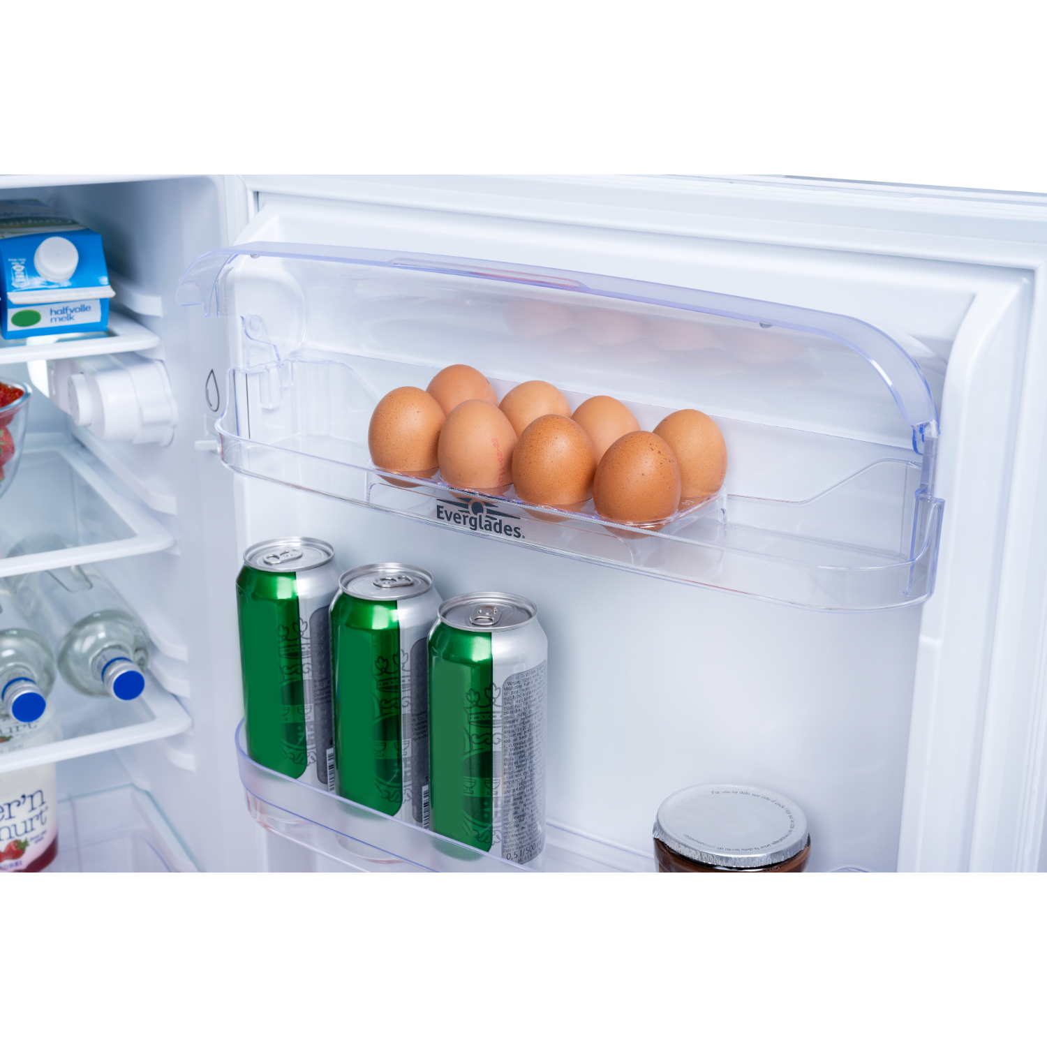 Inside refrigerator: eggs, cans, bottles and a jam jar. Shelves are clear.