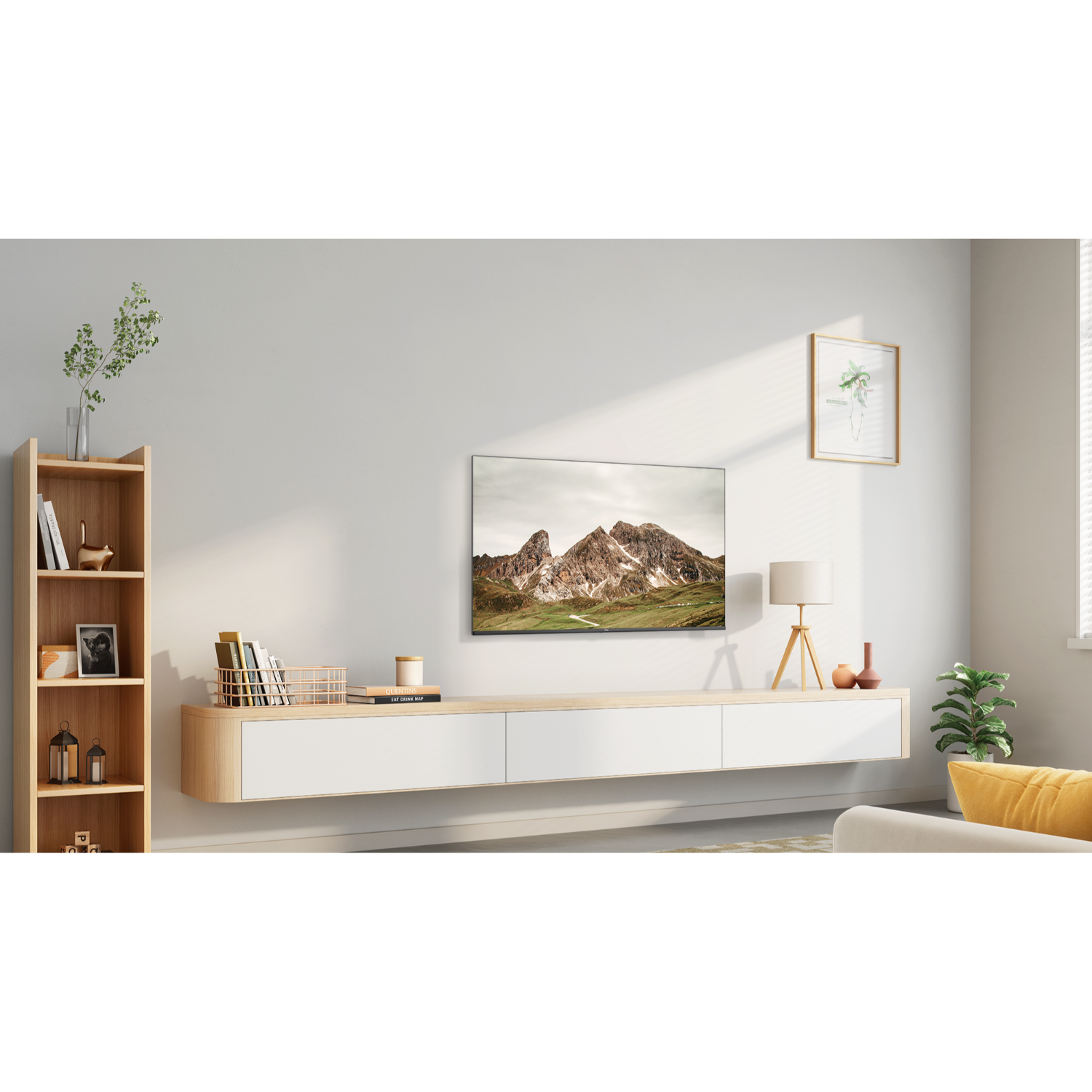 A living room with a TV on the wall, a bookshelf, and a window with a view of mountains.