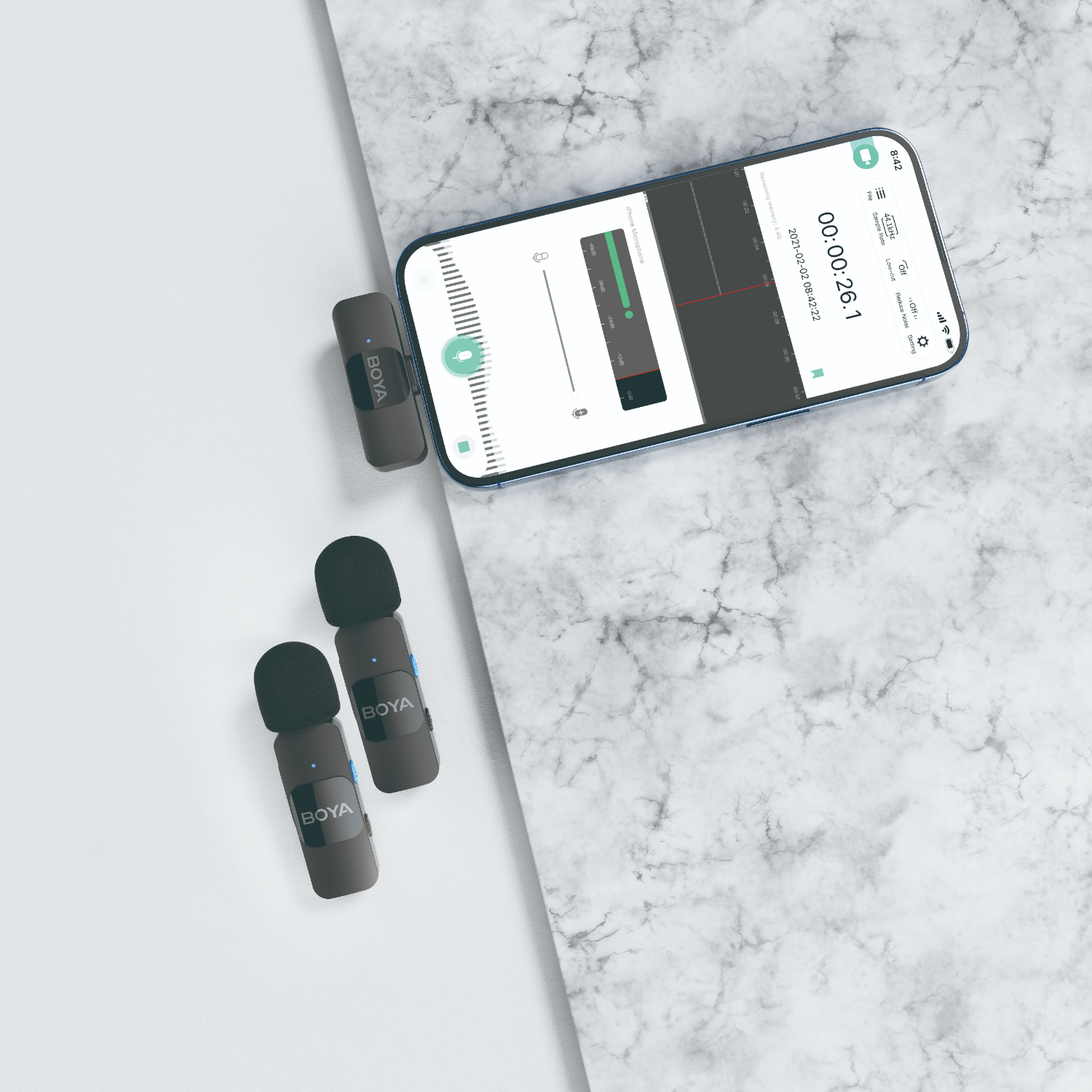 Phone with microphone kit. Two black microphones and a receiver are on a marble surface.