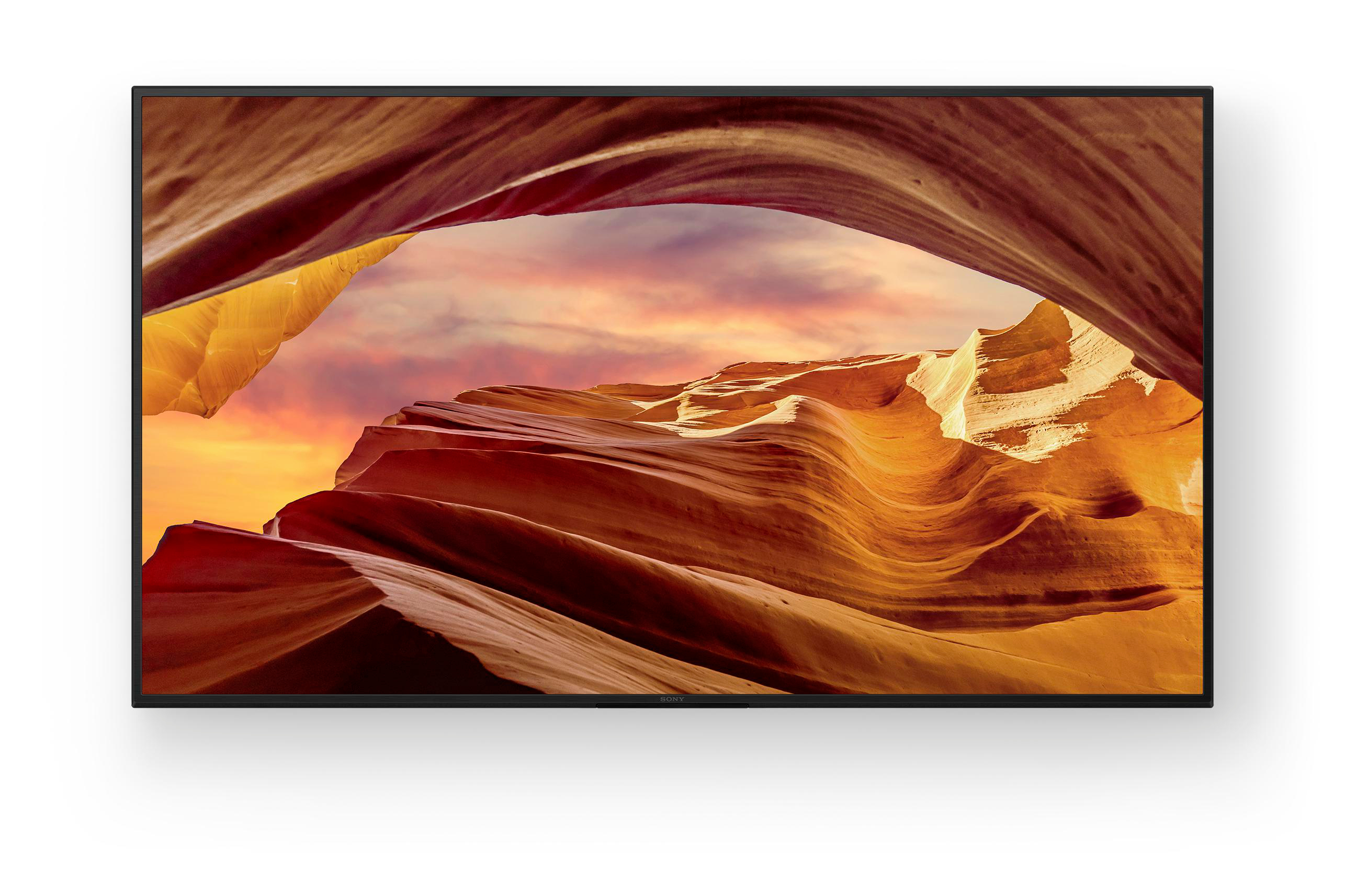 Ein Fernseher, der eine Schluchtszene mit orangefarbenen und braunen Felsformationen unter einem Sonnenuntergangshimmel zeigt.
