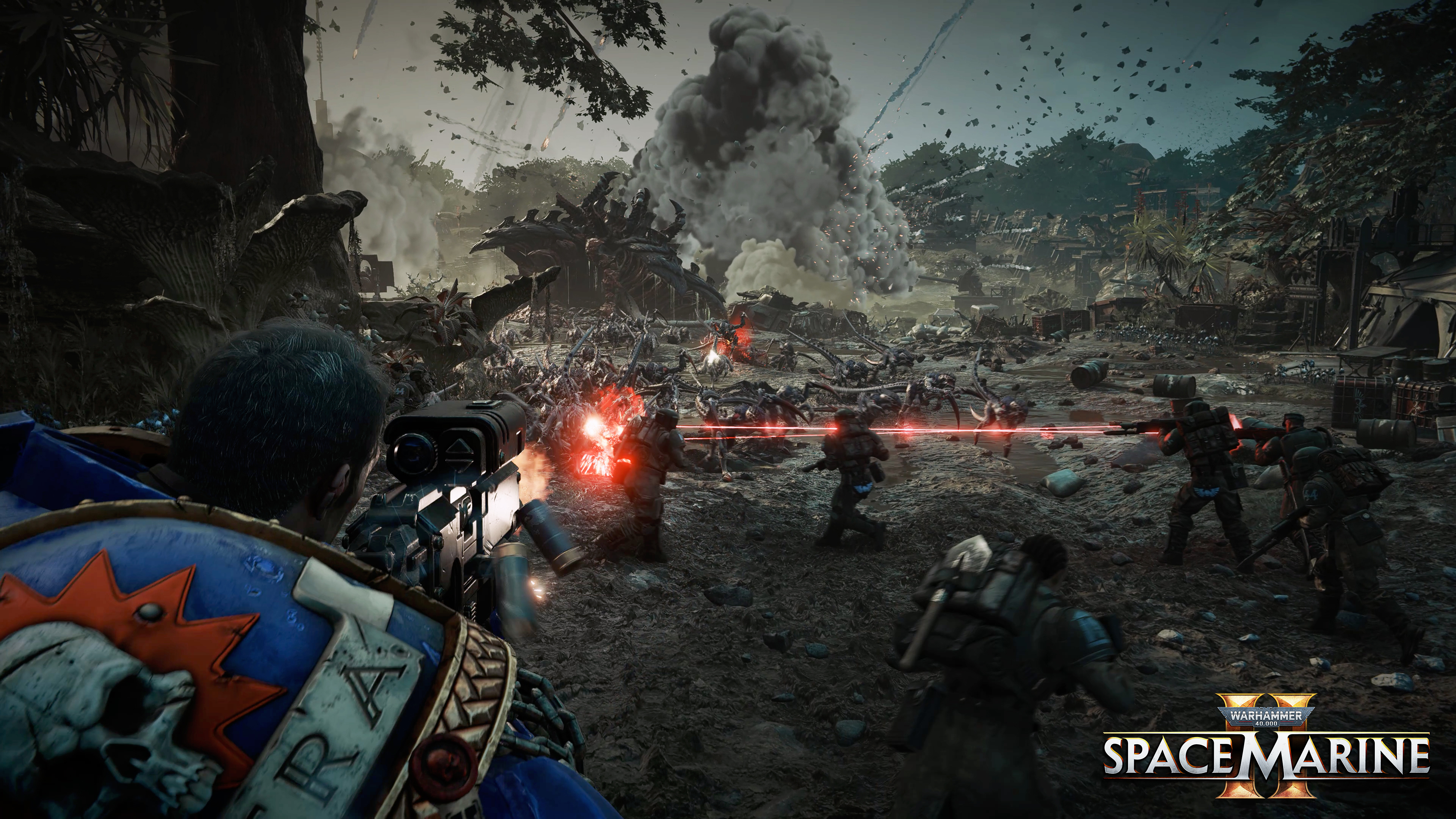 Scena z gry Warhammer 40,000 z żołnierzami strzelającymi z broni do stworzeń w strefie wojny.